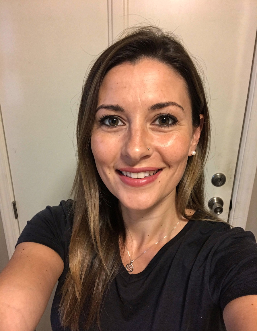 Approved sample sitter photo for the Lady Manners example: a smiling woman with long brown hair in a black T-shirt.