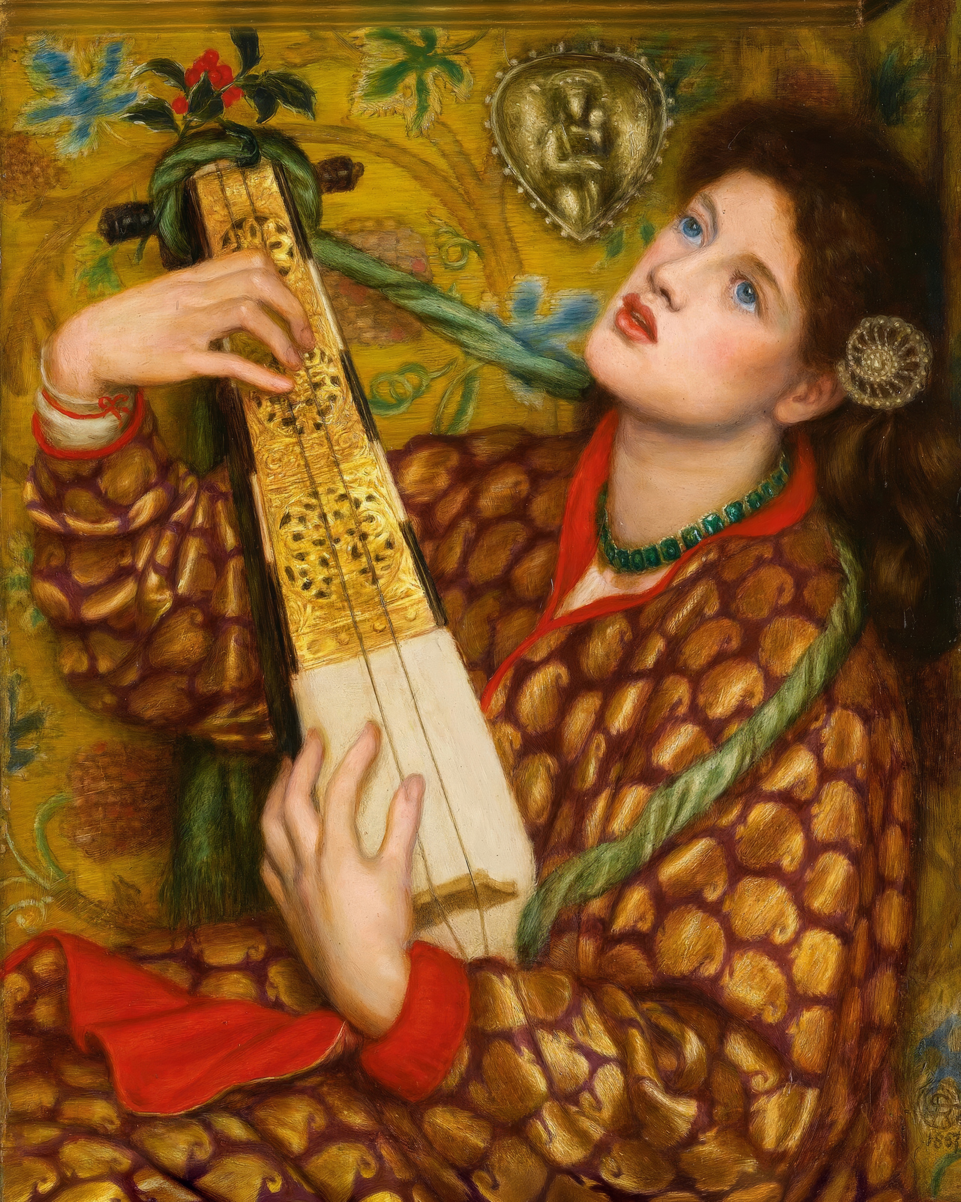 Dante Gabriel Rossetti's A Christmas Carol: a red-haired woman in a gold patterned robe plays a stringed instrument tied with holly.