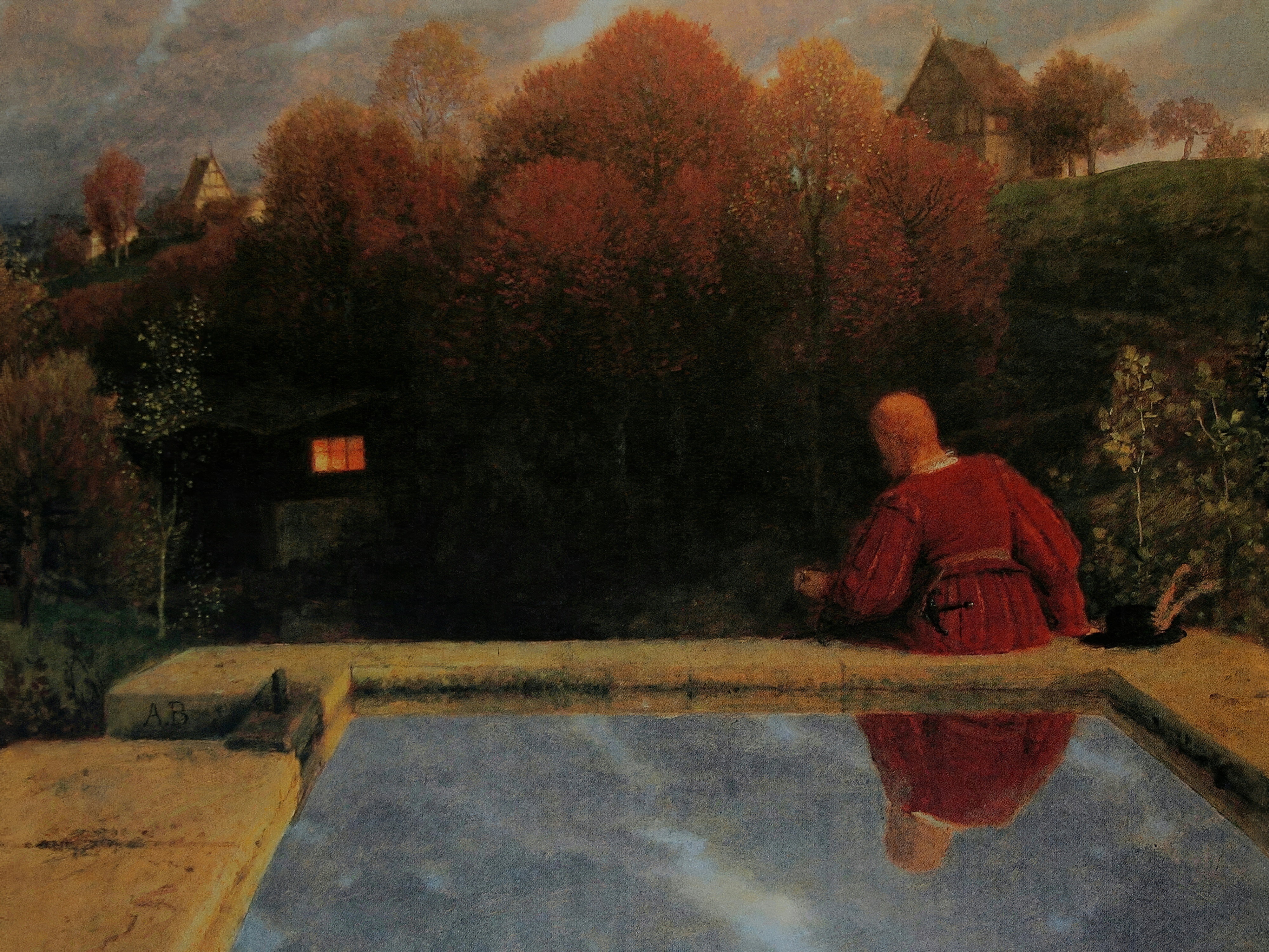 A figure in a deep red tunic sits by a pool at dusk, near a cottage with one lit window.