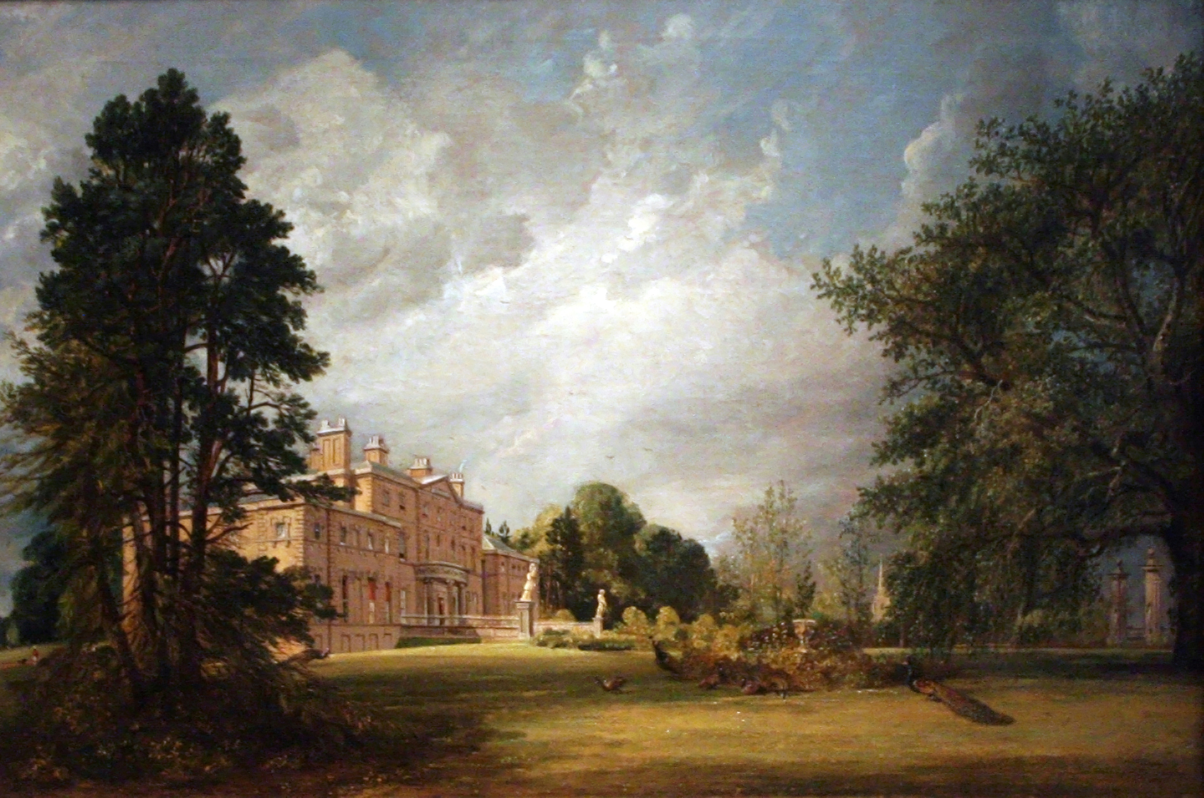 A stone manor with tall chimneys behind a lake, framed by dark trees.