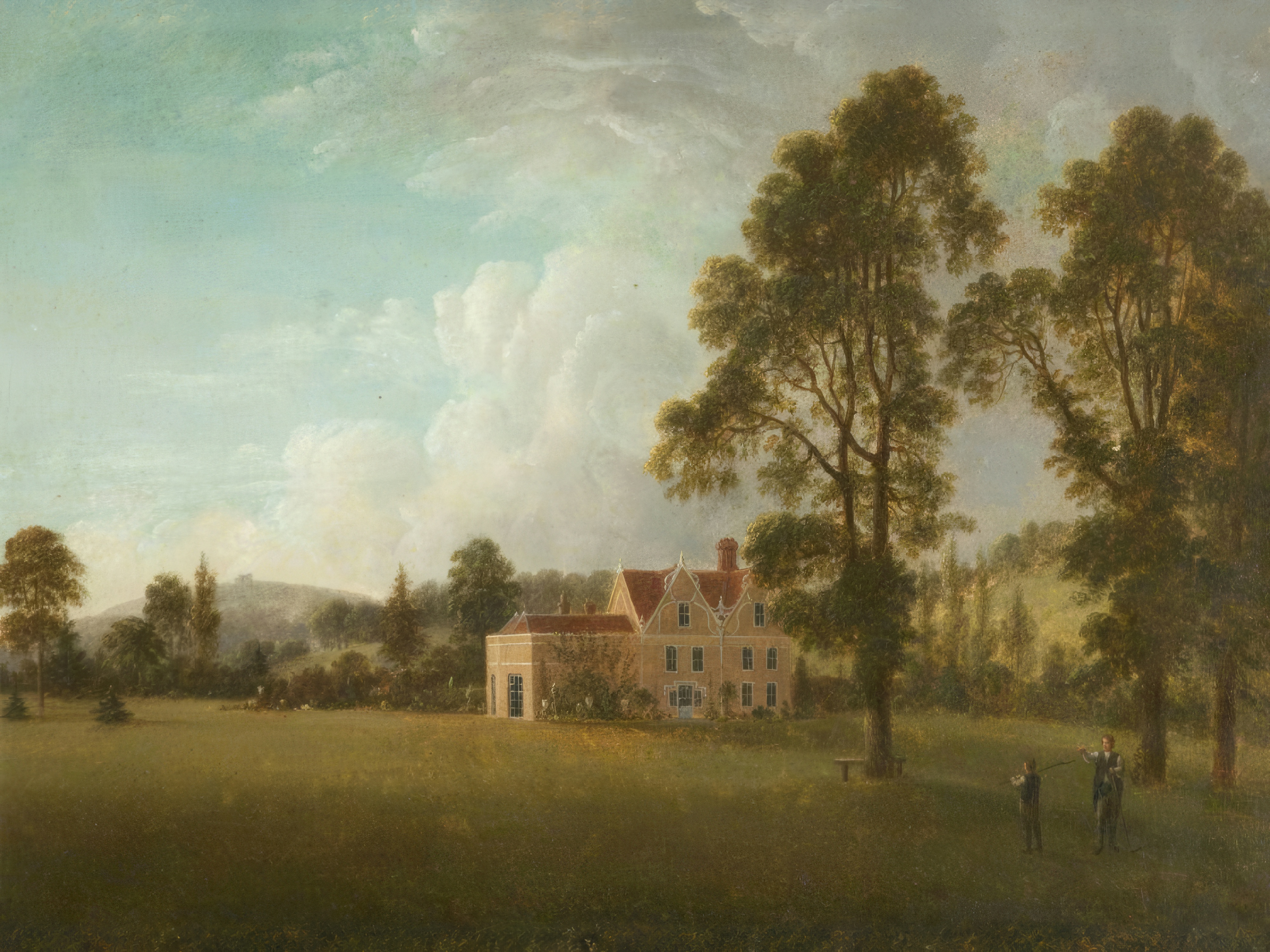 A pale manor among great trees in a sweeping English landscape under soft clouds.