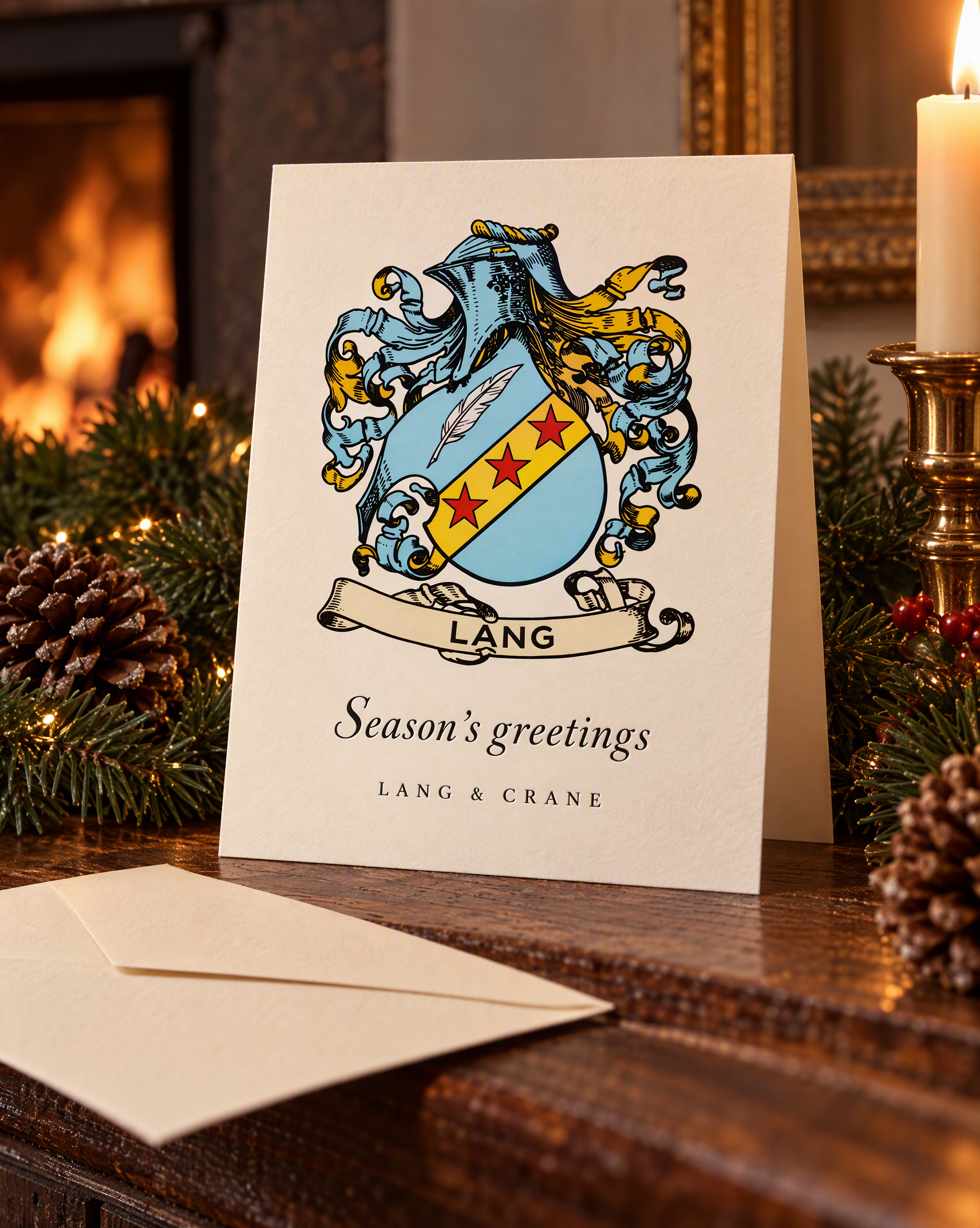 A Season's greetings card from Lang & Crane with a pale blue coat of arms, standing on a mantelpiece with fir garland, pine cones and a candle.