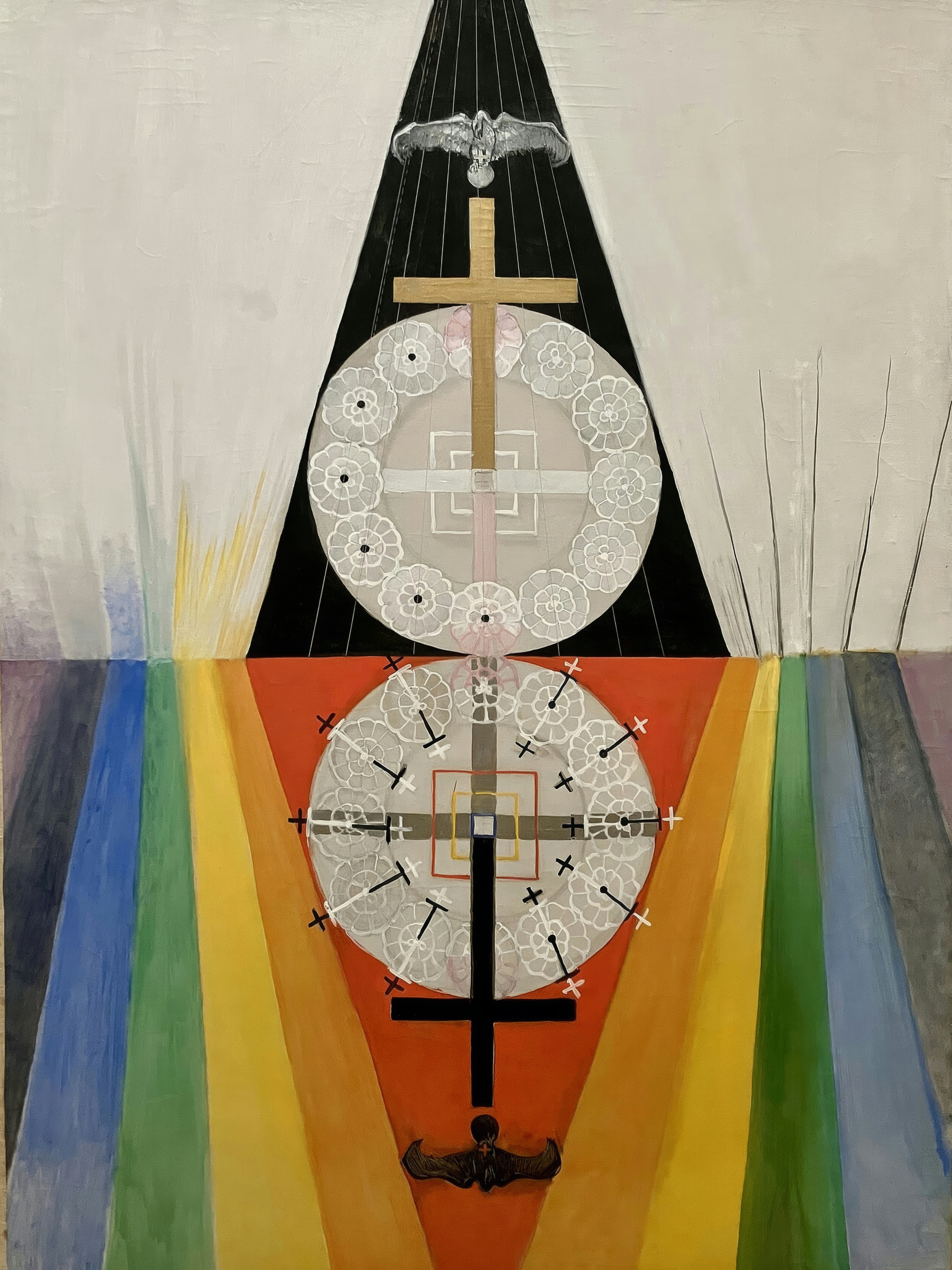 A silver eagle and a gold cross above, a mirror image in shadow below, split by triangles of black and red.