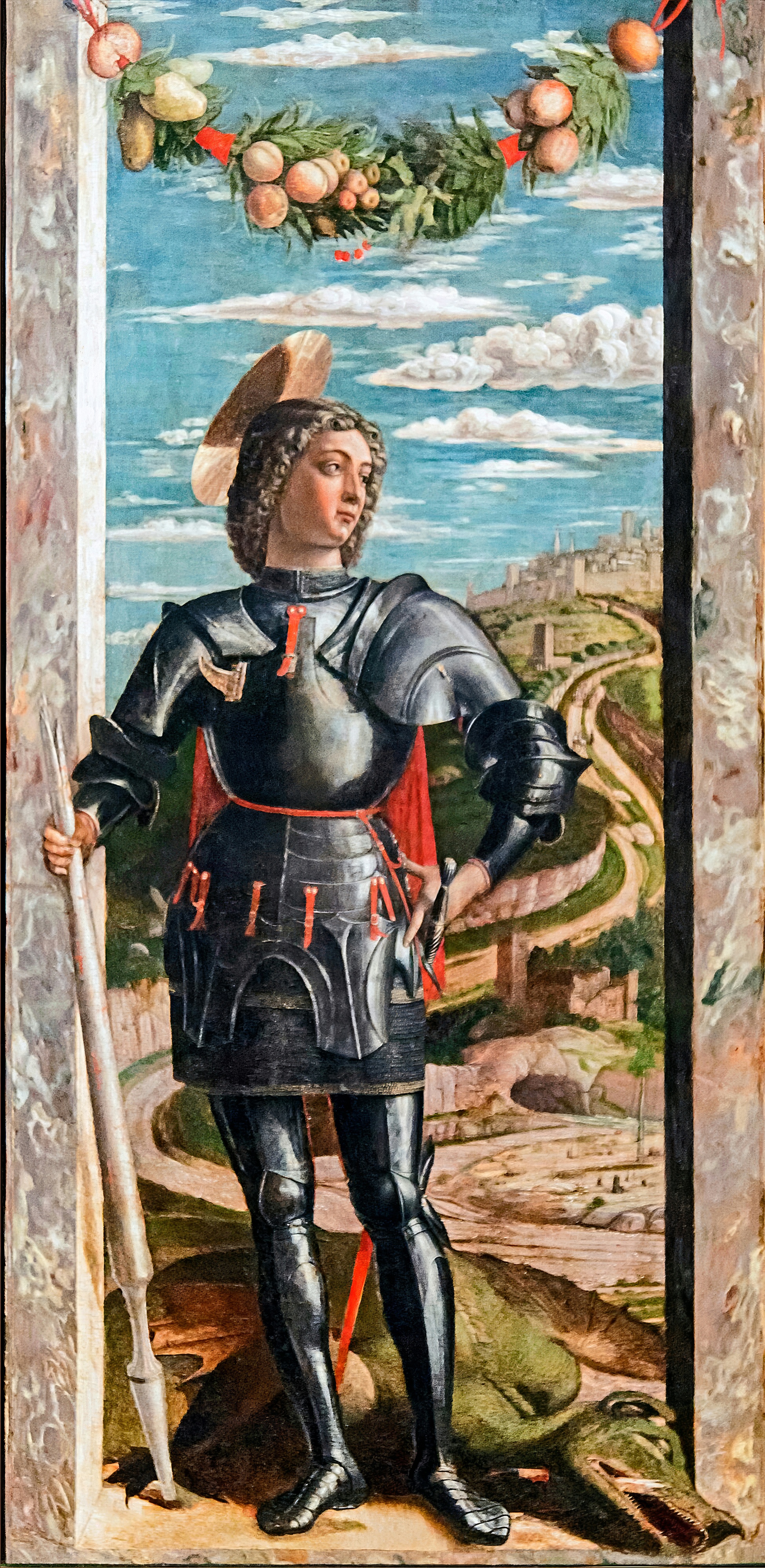 A young knight in shining armour stands in a stone archway hung with a garland of fruit, the dragon at his feet.