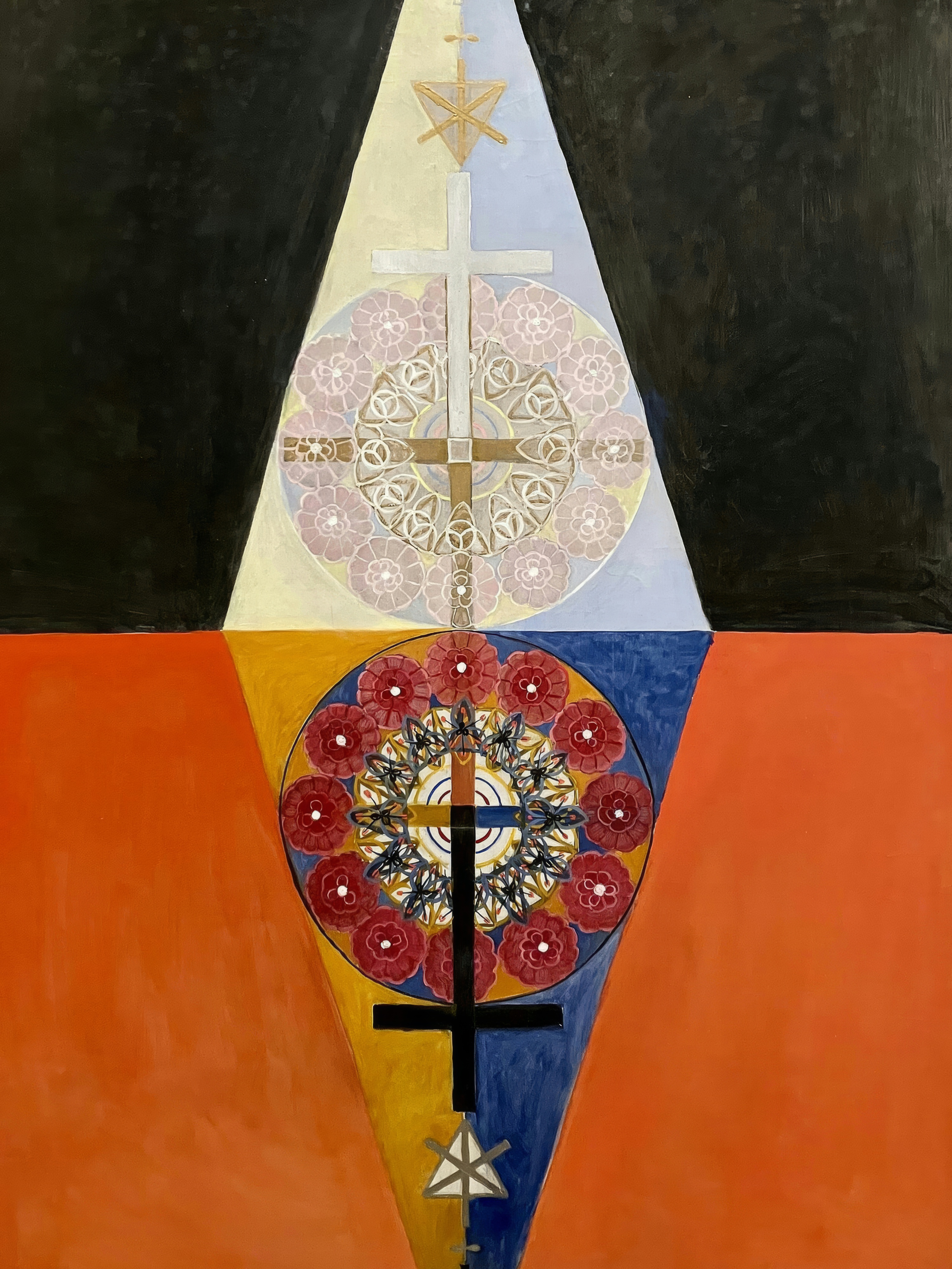 A black upper half and an orange lower half, joined by mirrored triangles and mandalas.