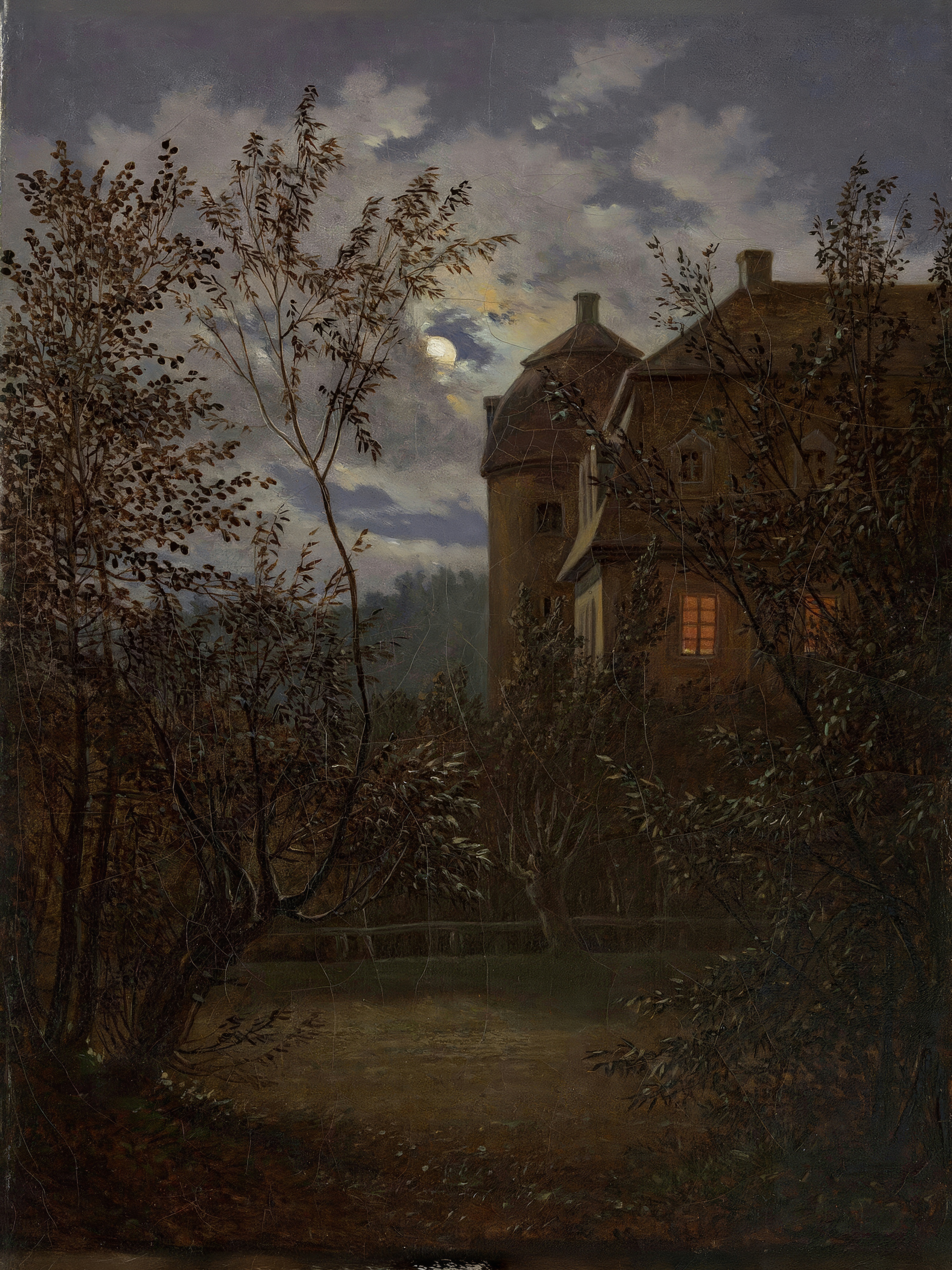 A dark manor house stands behind bare trees under a cloudy night sky, one window glowing.