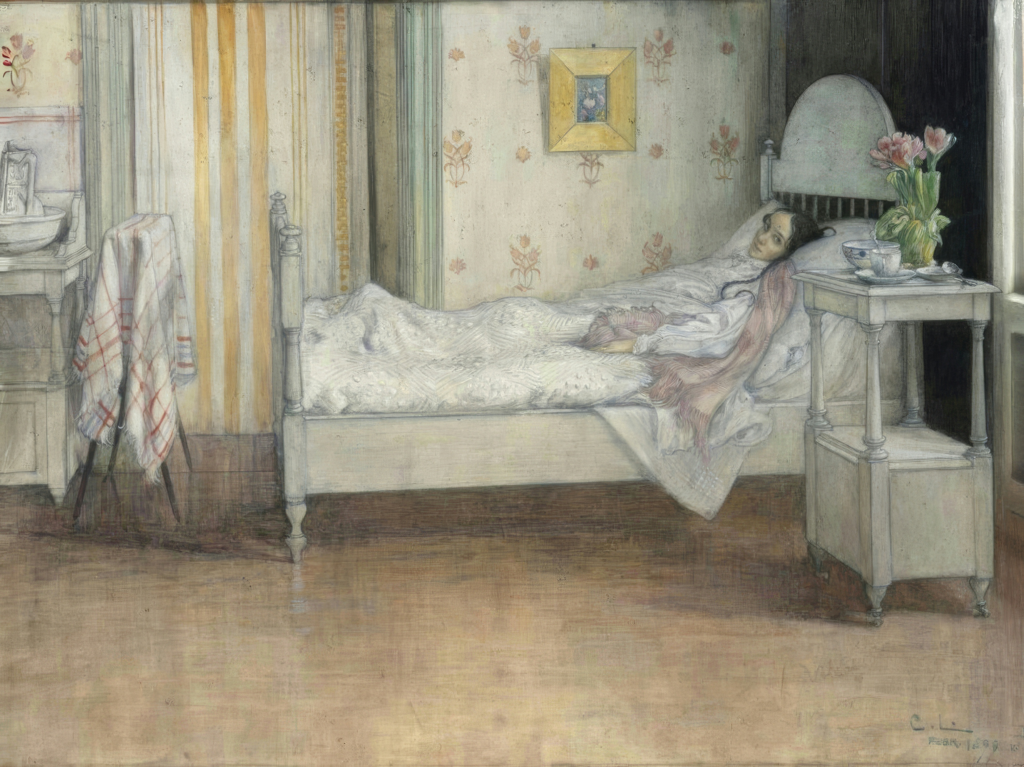 A young woman rests in a bright bedroom in white linen and a pink shawl, with tulips on the nightstand.
