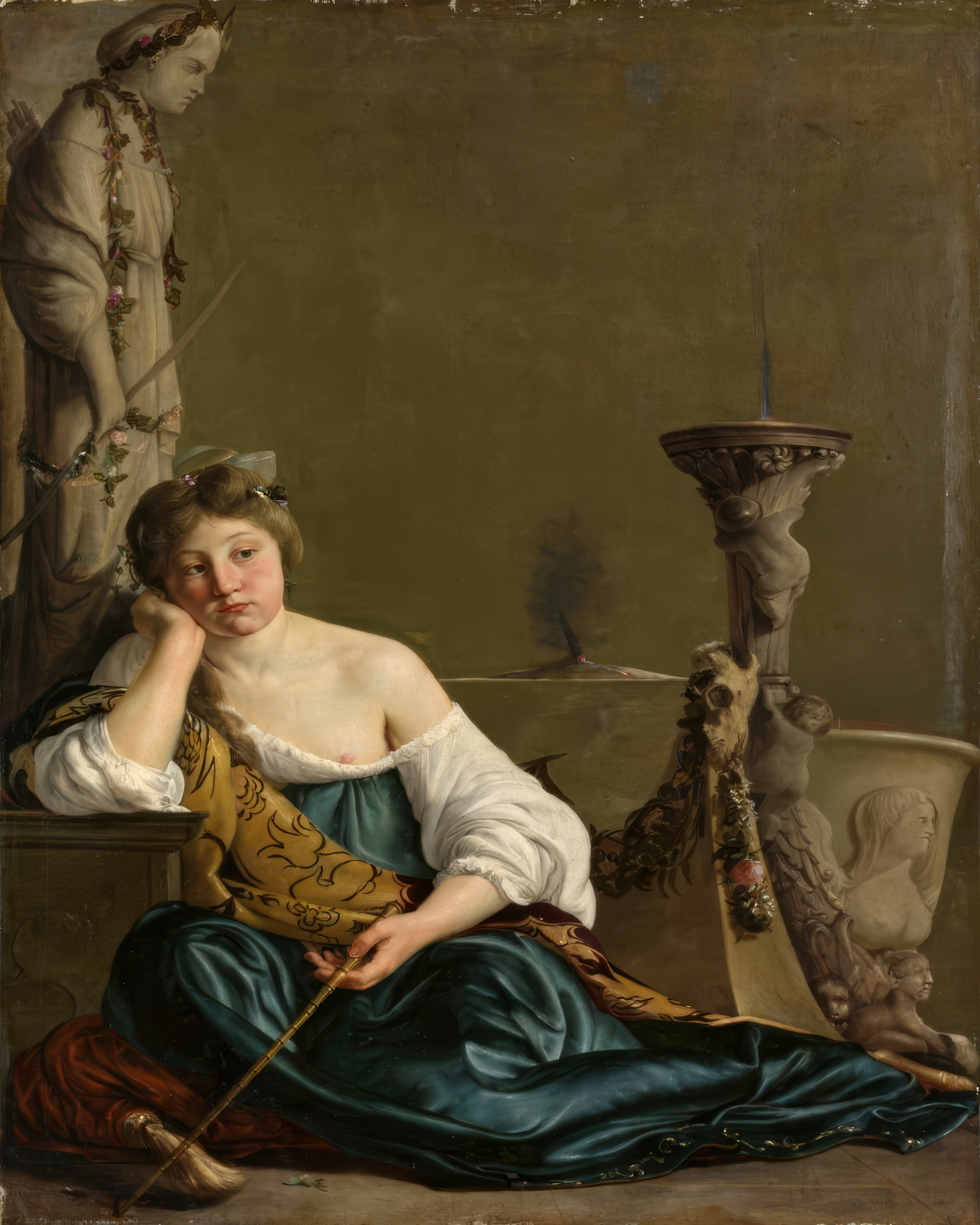 A young woman in a blue satin dress leans on a ledge holding a wand, beside an altar and a garlanded statue.