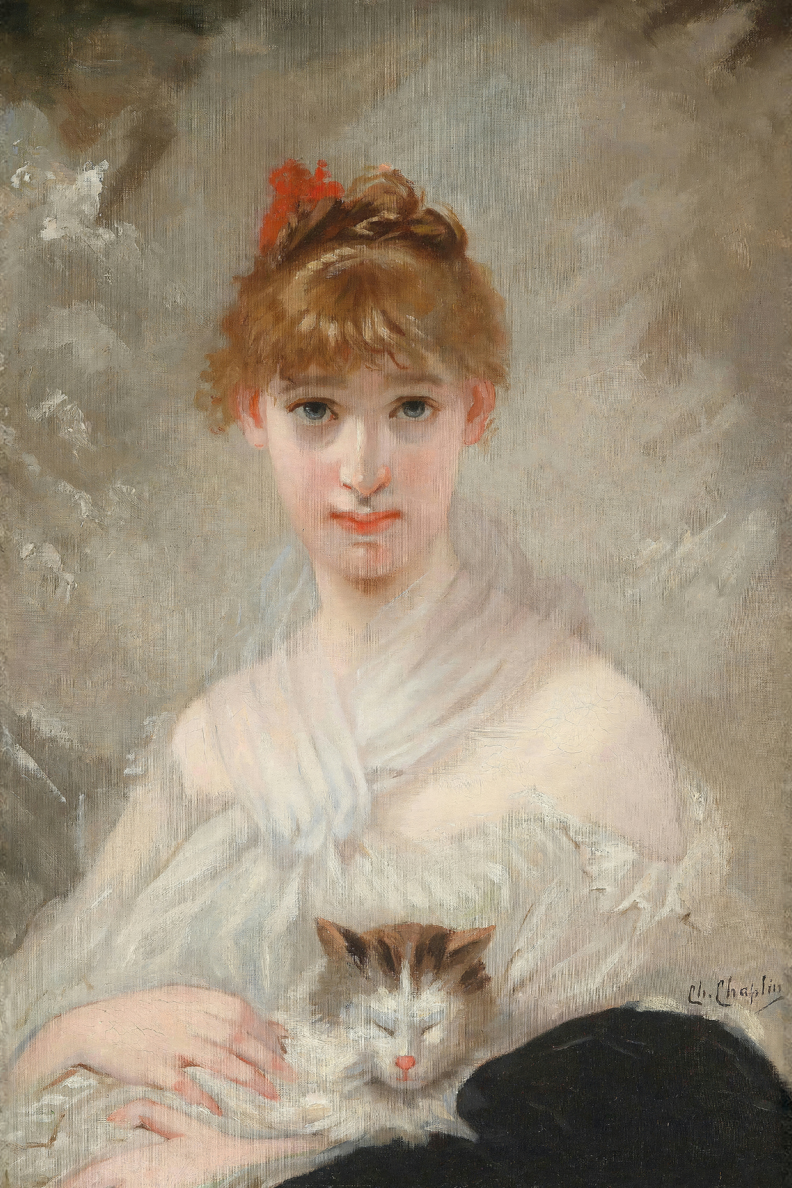 A young woman with auburn hair, wrapped in a sheer white shawl, holds a sleeping brown and white cat in her lap.