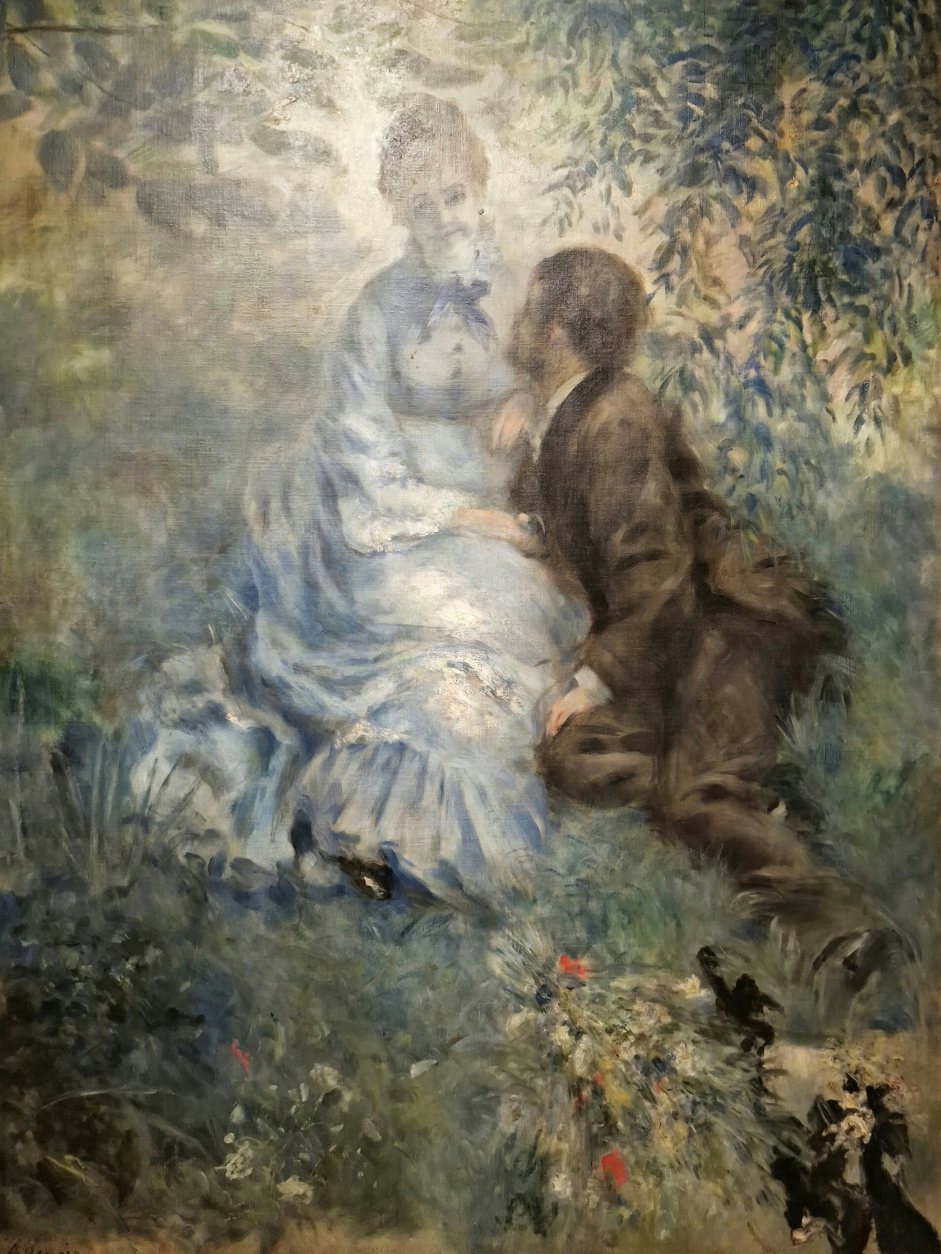 A woman in a pale blue-grey dress and a man in black leaning close to her, seated in a shady garden painted in loose blue and green strokes; painted by Pierre-Auguste Renoir.