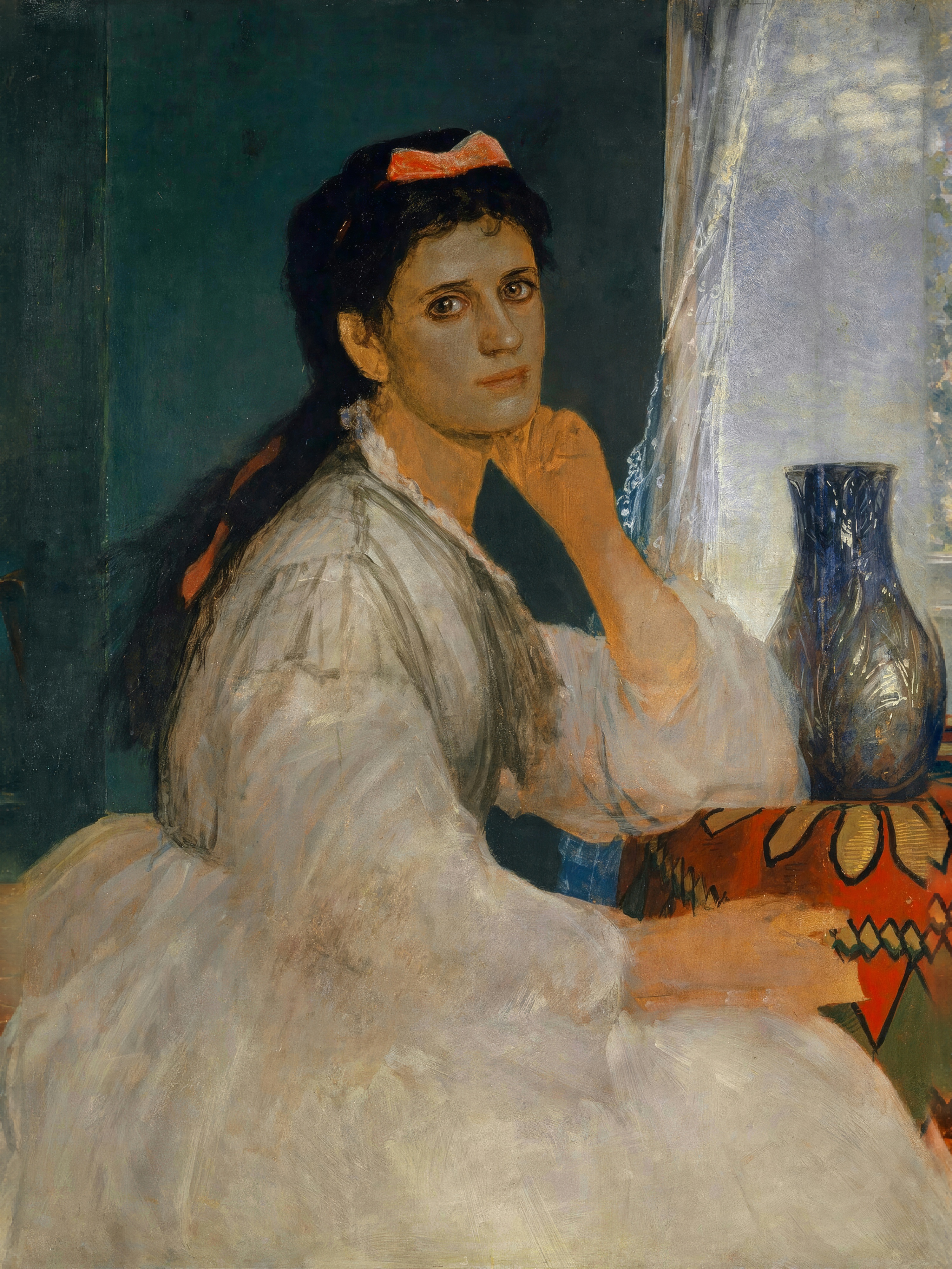 A woman in a white dress sits by a window, light falling across her face.