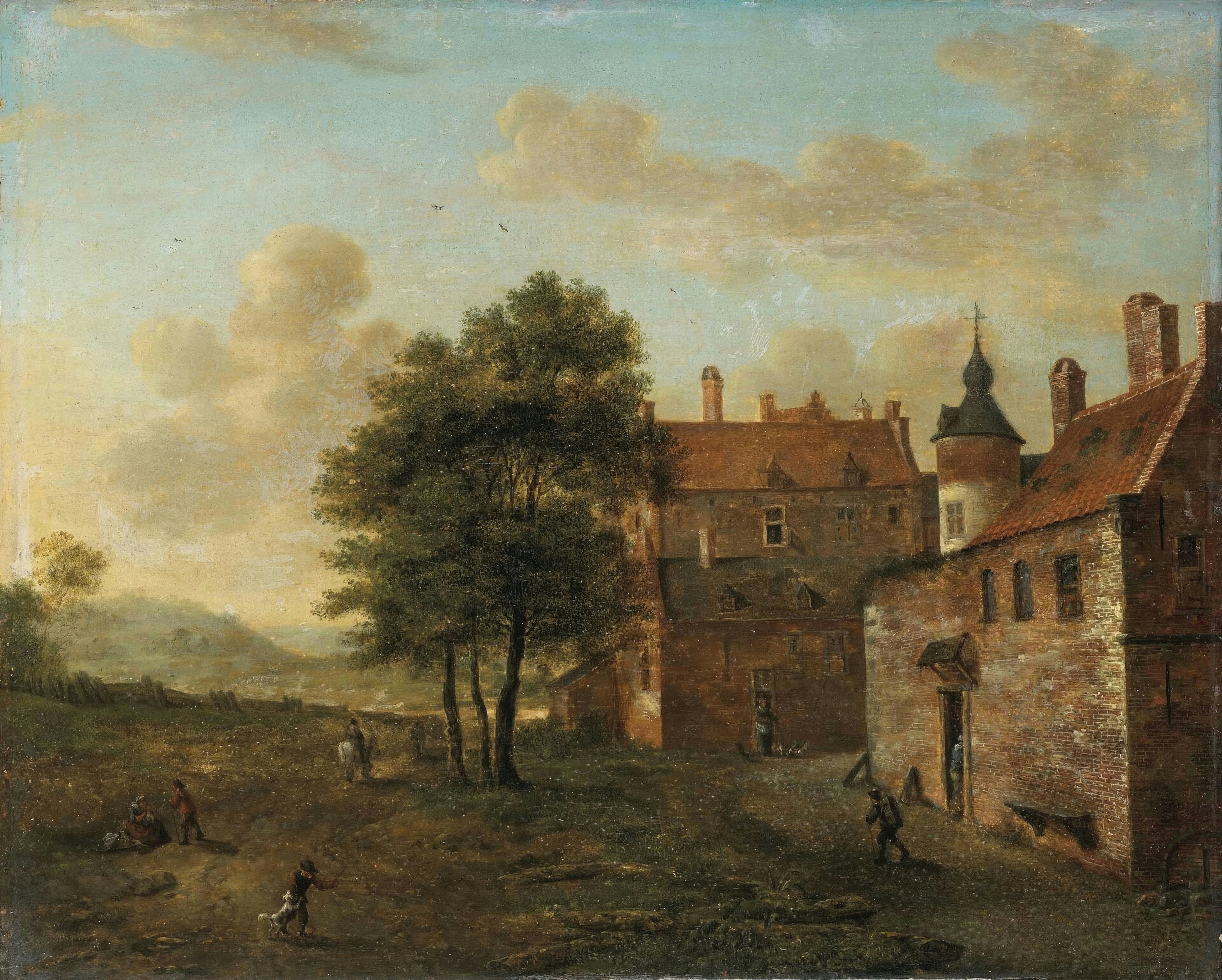 A brick manor house with turrets and stepped gables stands among trees on a sunny afternoon, with figures on the lawn.