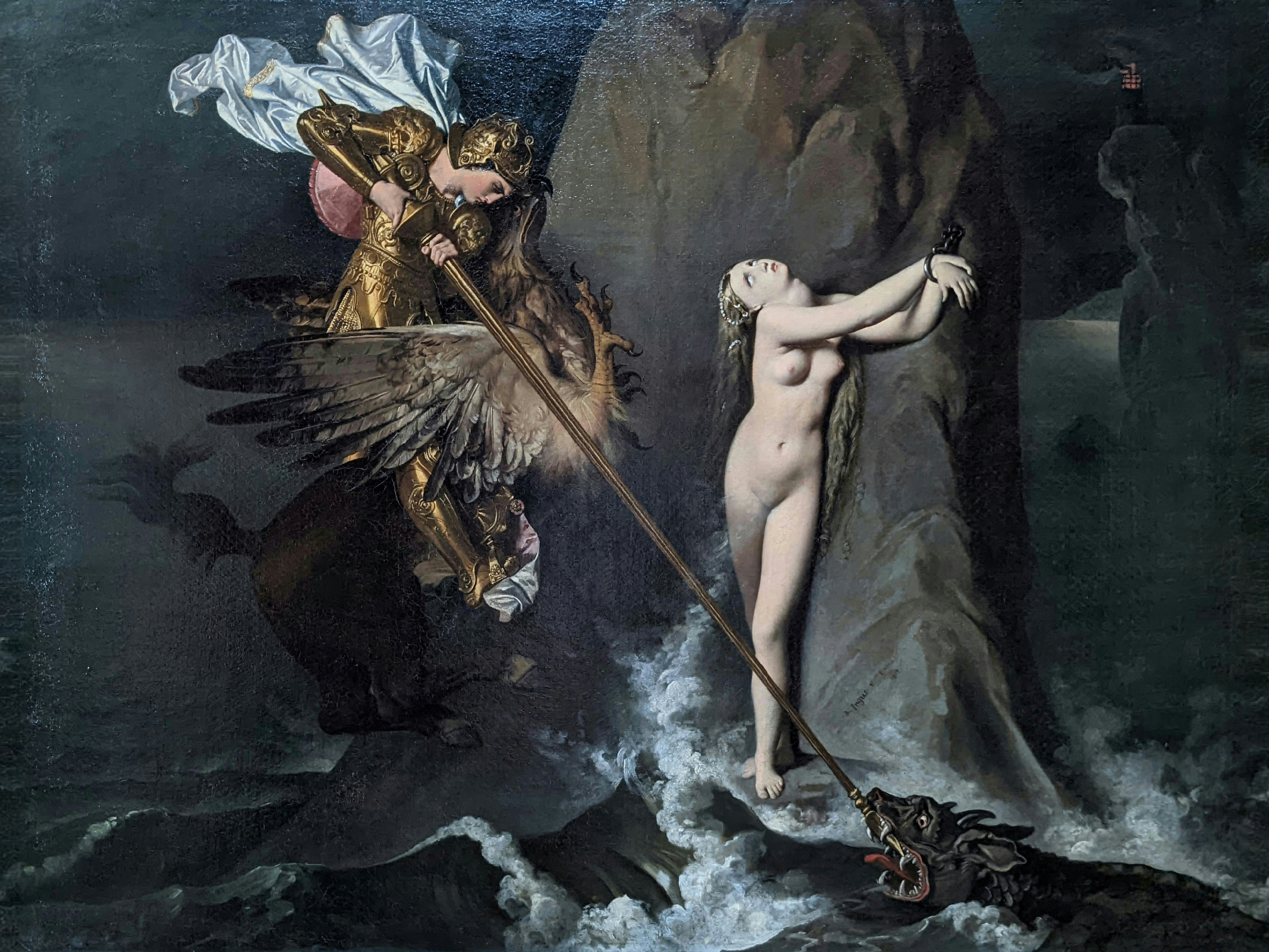 A knight on a winged hippogriff spears a sea monster beside a pale woman chained to a rock.
