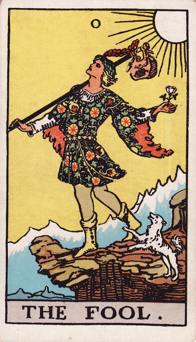 The Fool, card 0 of the Rider–Waite–Smith tarot: a young traveller with a white rose and a bundle steps toward a cliff edge, a small white dog at his heels.