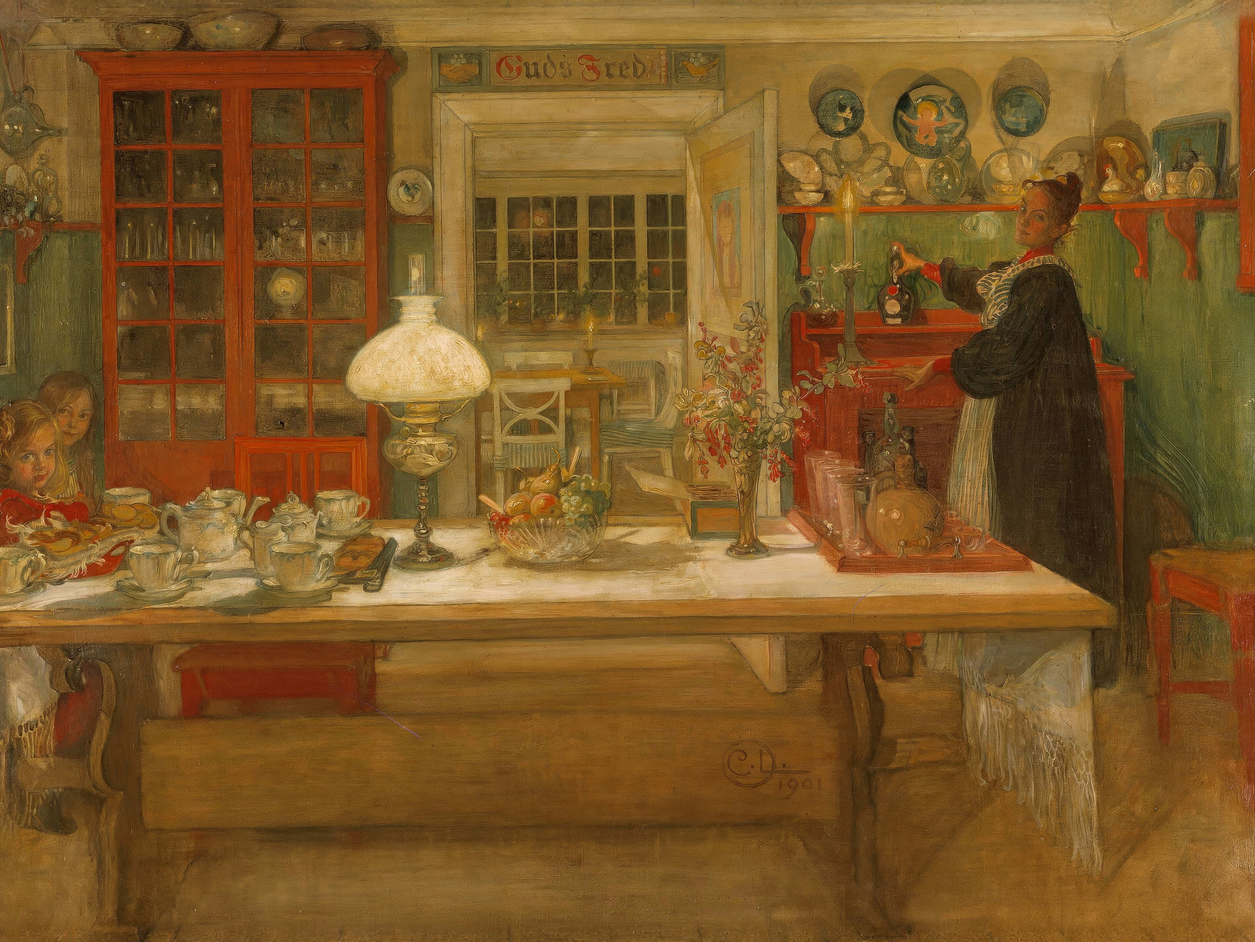 A family table is set for an evening game under a glowing oil lamp.