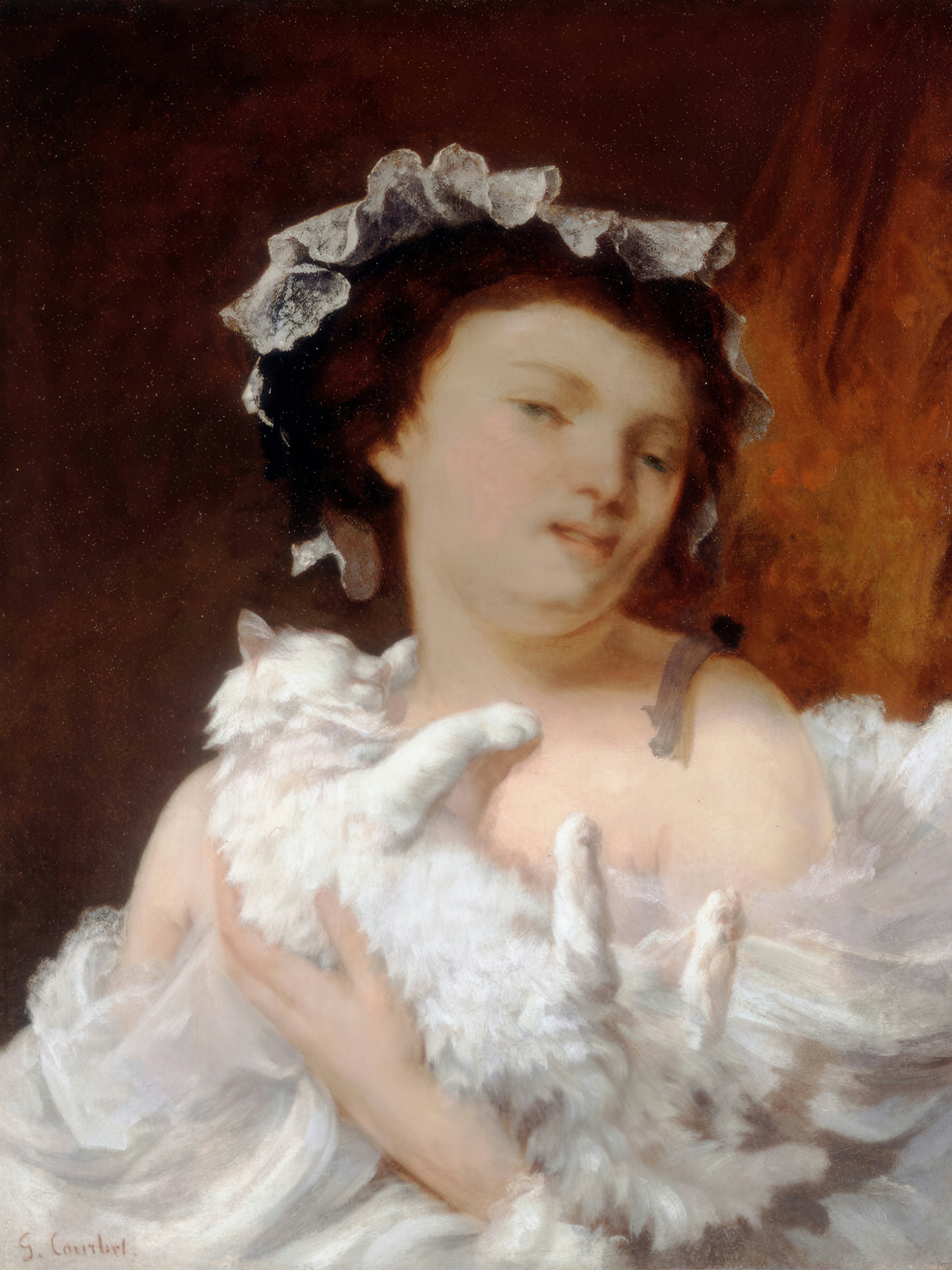 A young woman in a lace bonnet holds a fluffy white cat with grey markings against a dark background.