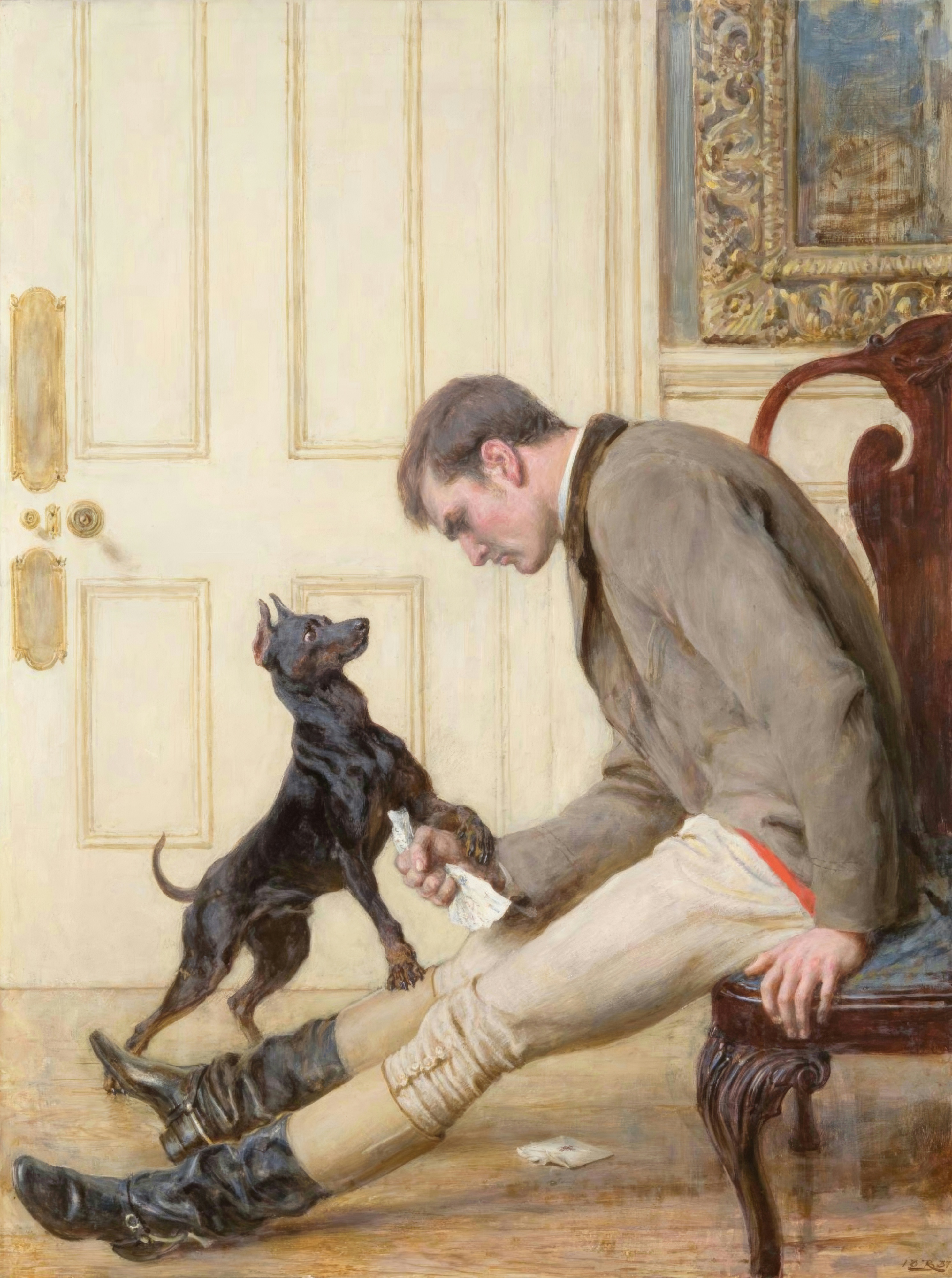 A young man slumps in a chair with a crumpled letter while his small black terrier comforts him.