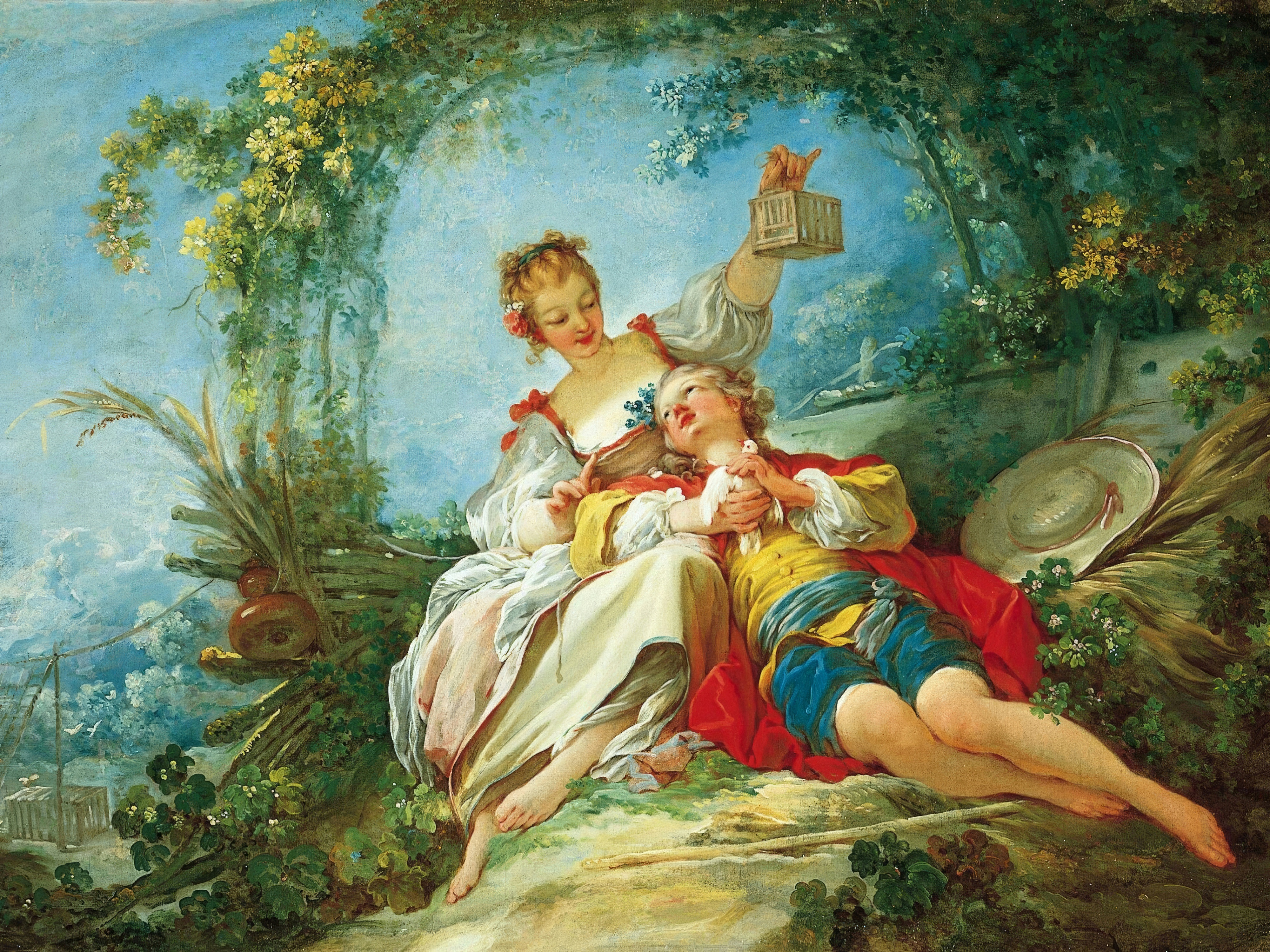 A young woman in white holding a small birdcage aloft while a young man in yellow and red lies in her lap, under an arch of flowering branches against a blue sky; painted by Jean-Honoré Fragonard.
