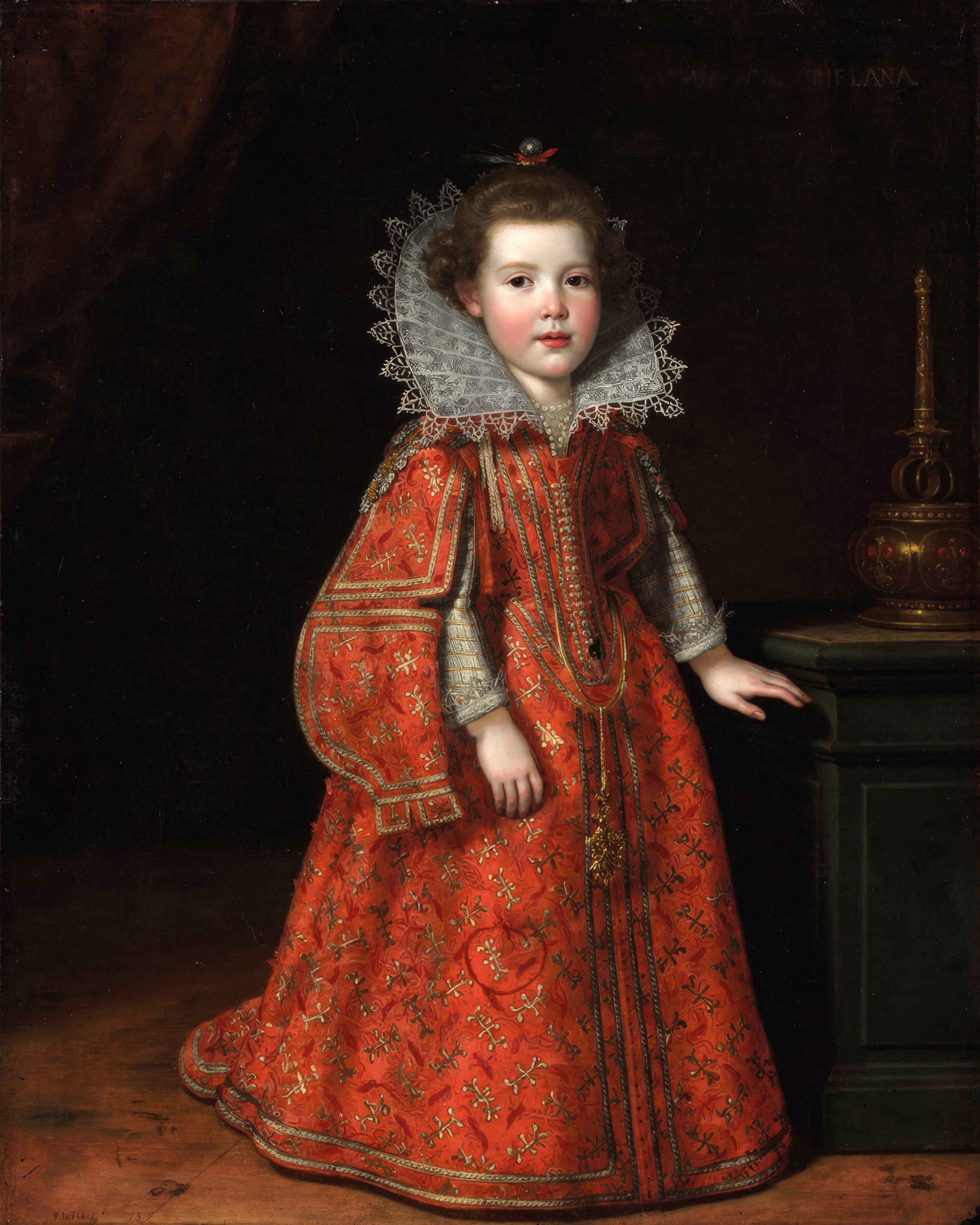 A small girl in crimson and black with a white lace collar.