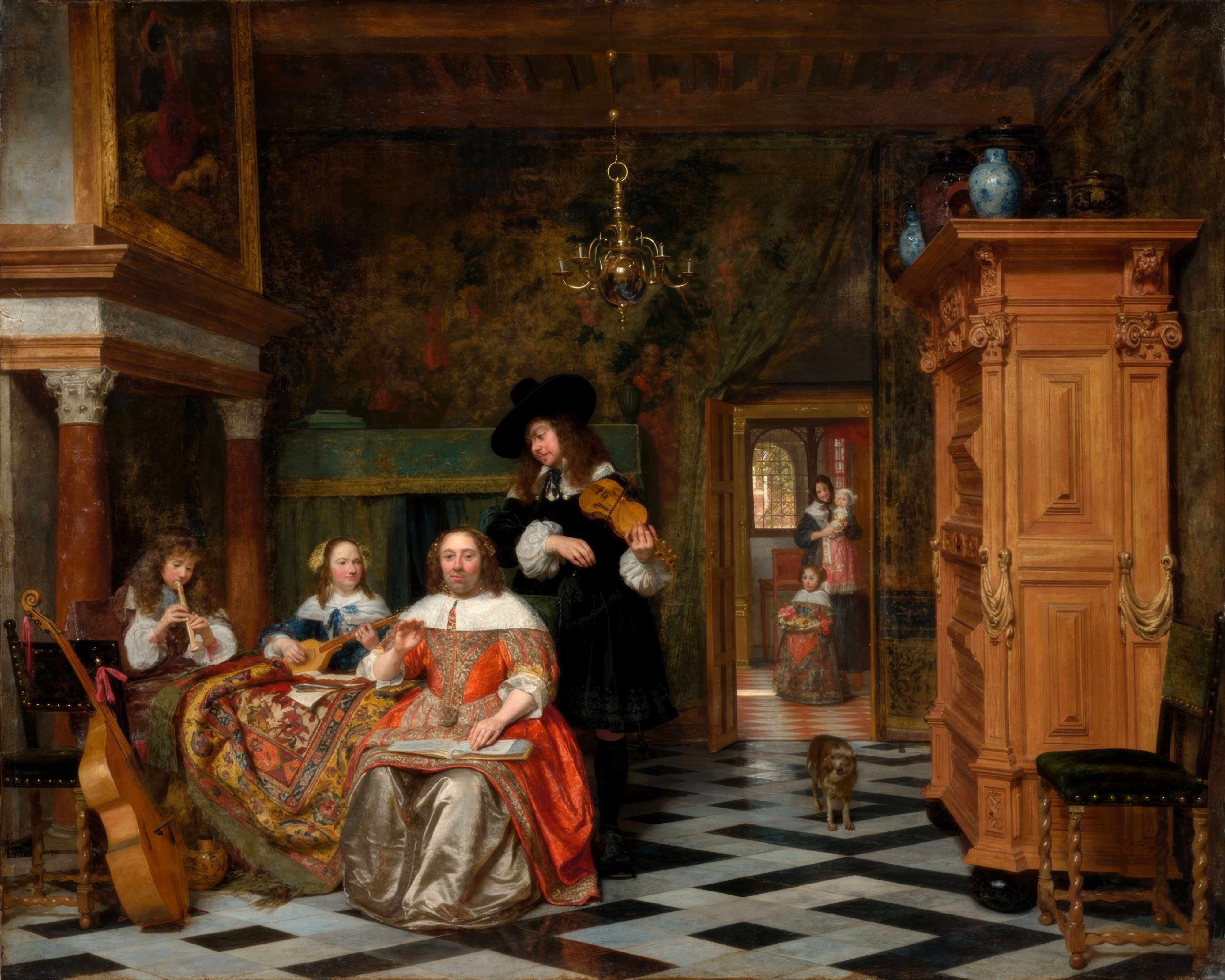 A Dutch family in a sunlit interior gathers around a keyboard instrument, a man with a viola da gamba beside them.