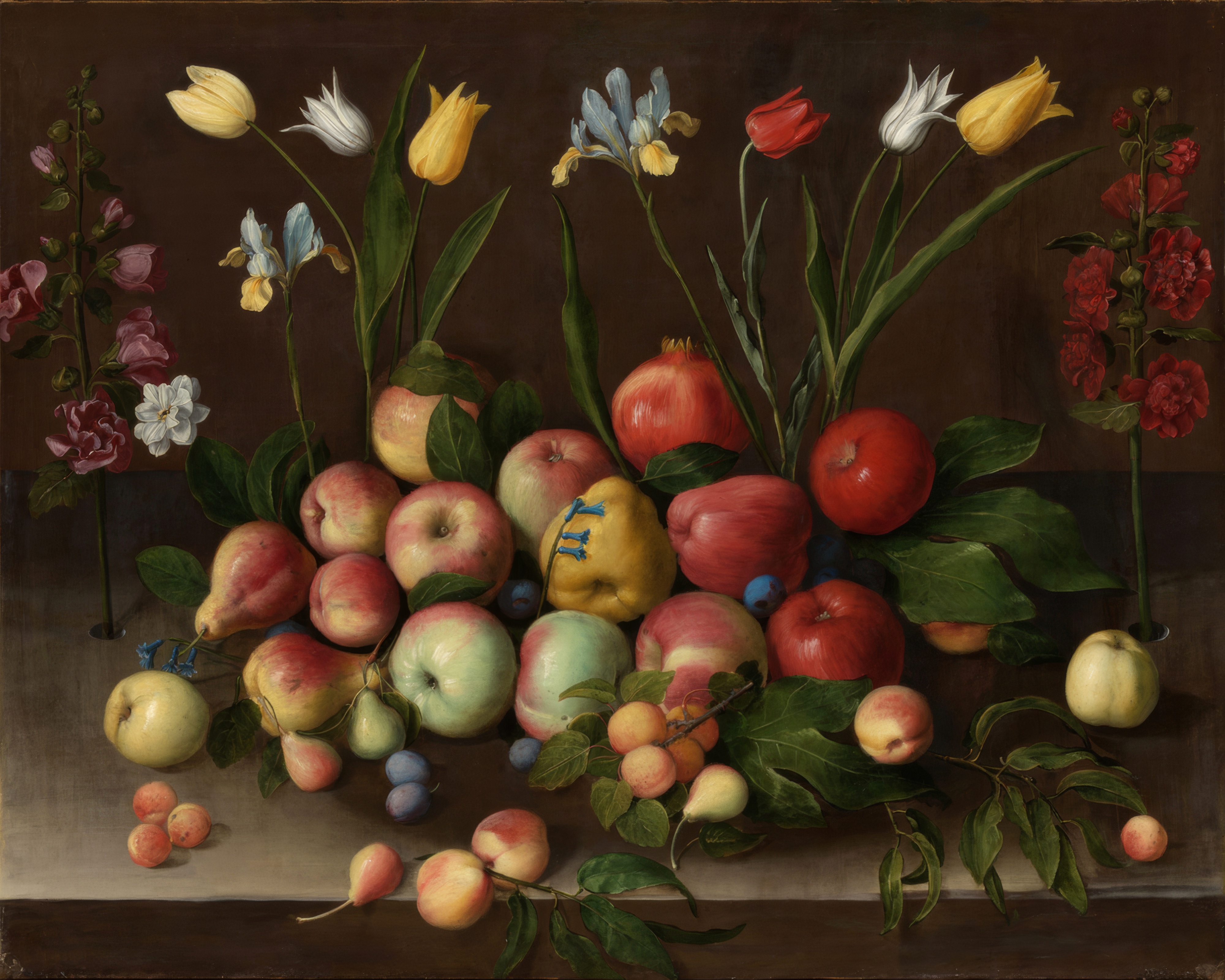 Flowers in a vase beside pears, grapes and other fruit, arranged simply against a dark background.