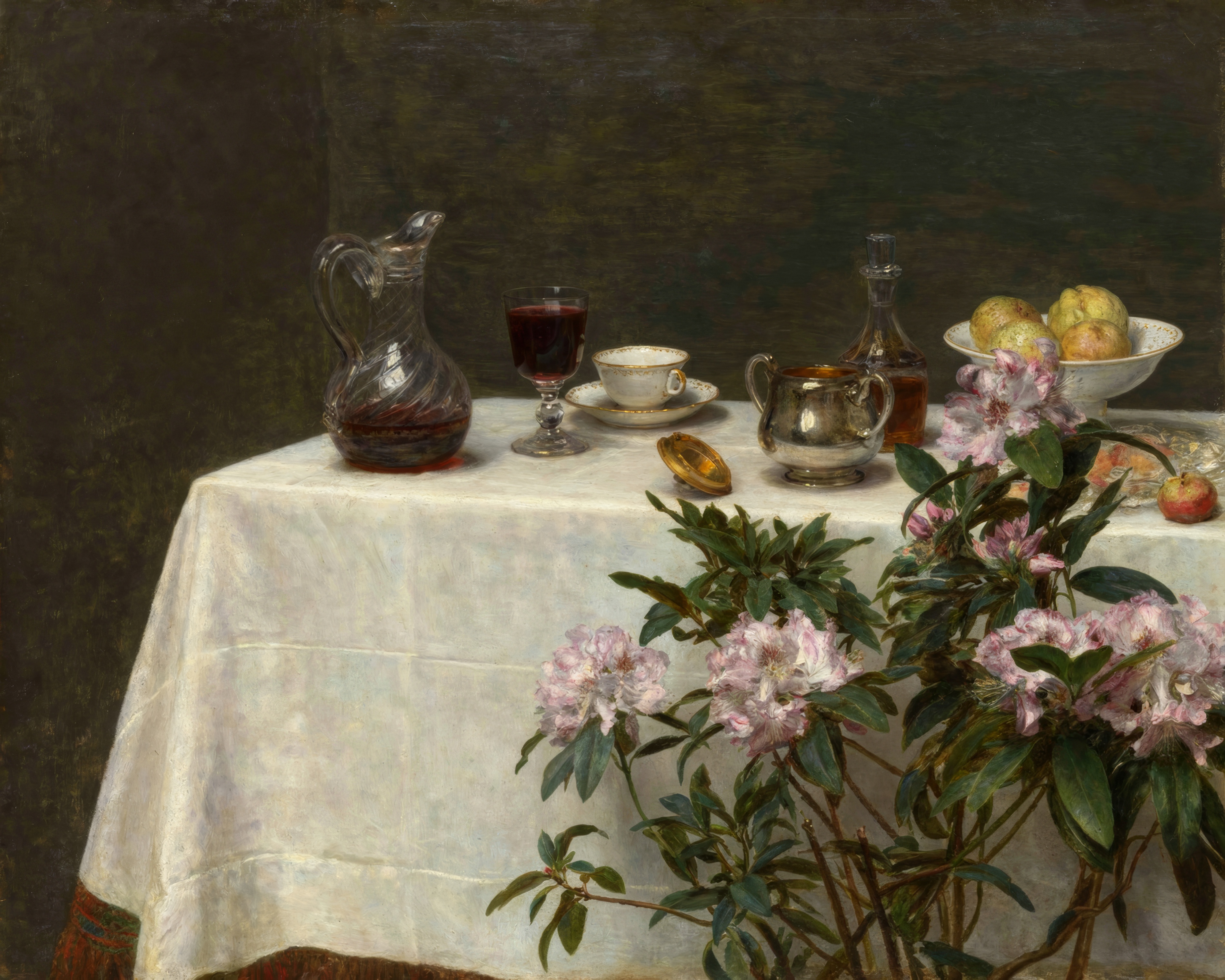 A cup and saucer, a glass with a single primrose and a silver spoon on the corner of a table.