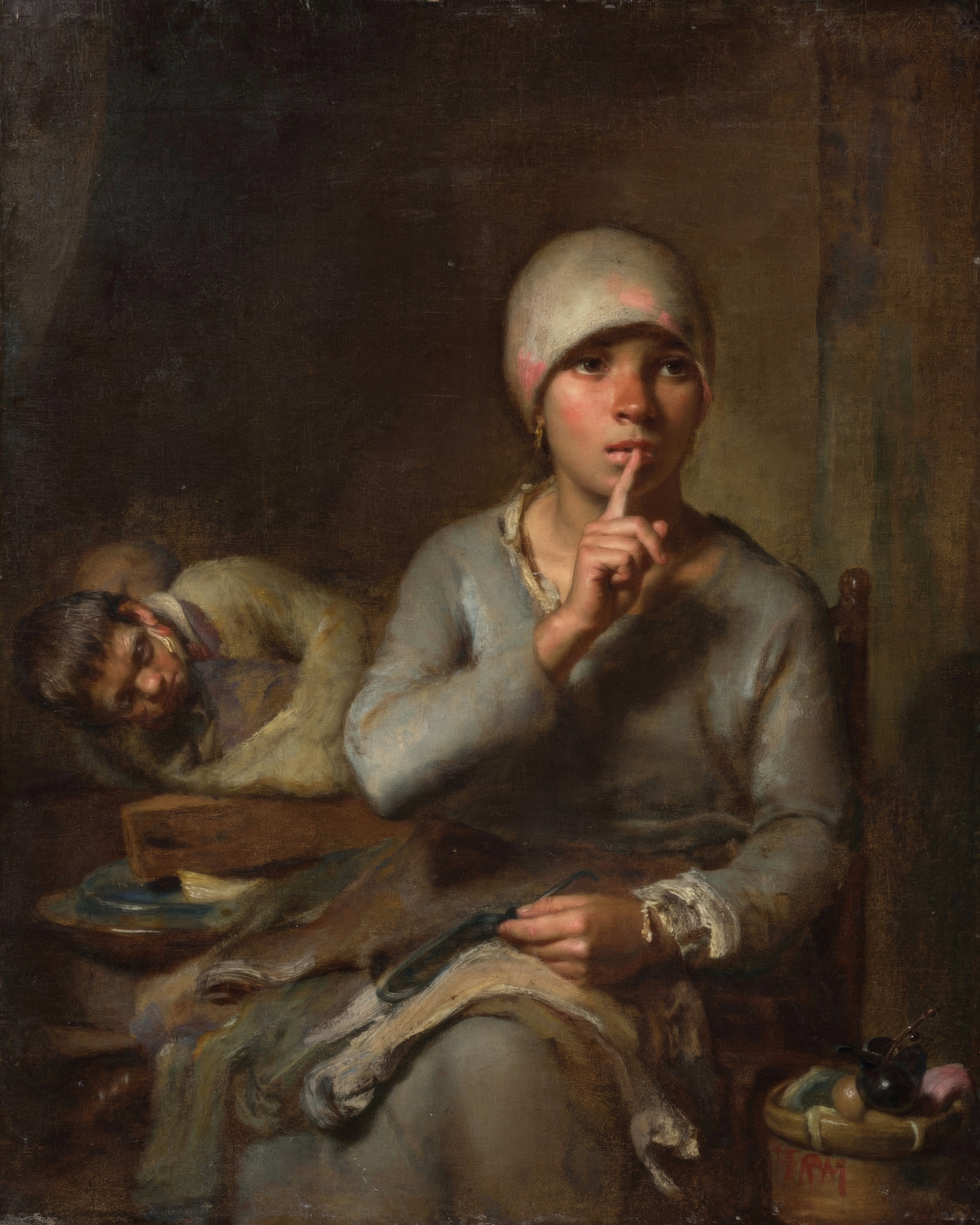 A mother holds a sleeping child against a dark background, a finger raised for silence.