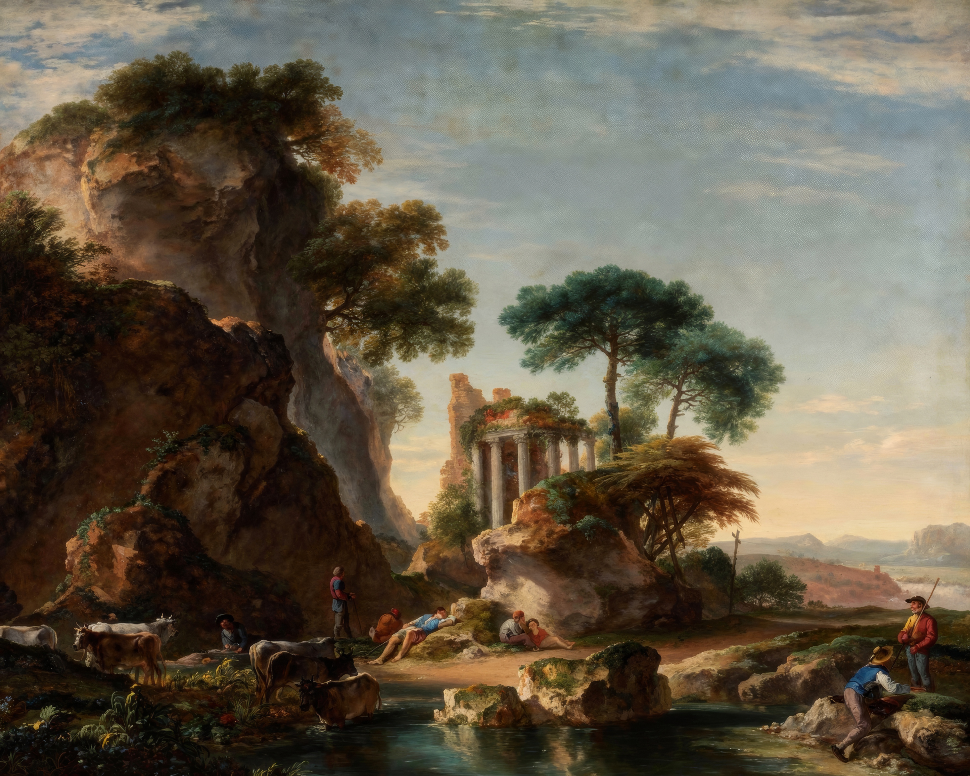A ray of light breaks through clouds onto classical ruins among craggy cliffs.