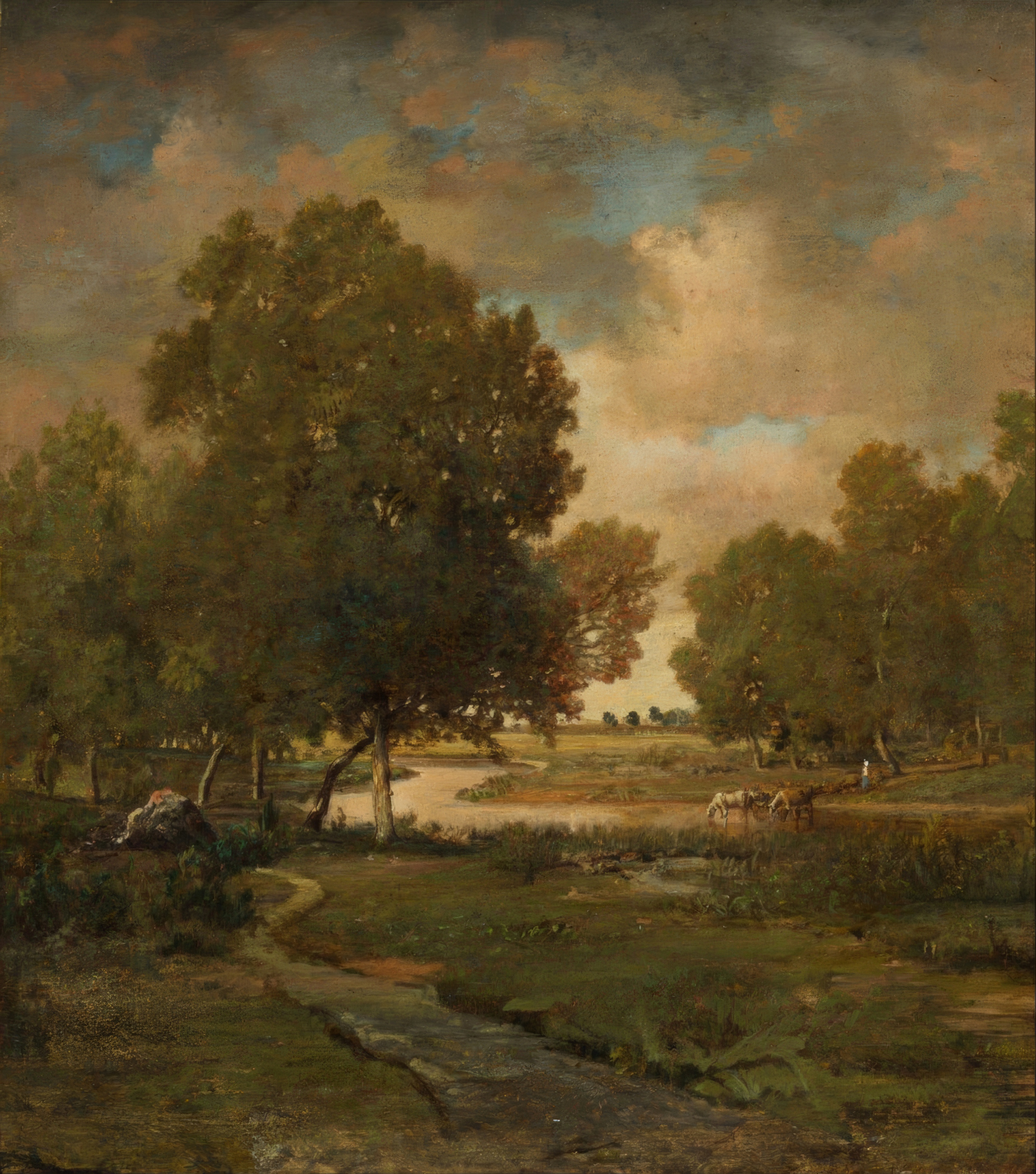 A slow river winds through a green meadow under a wide, cloudy sky.