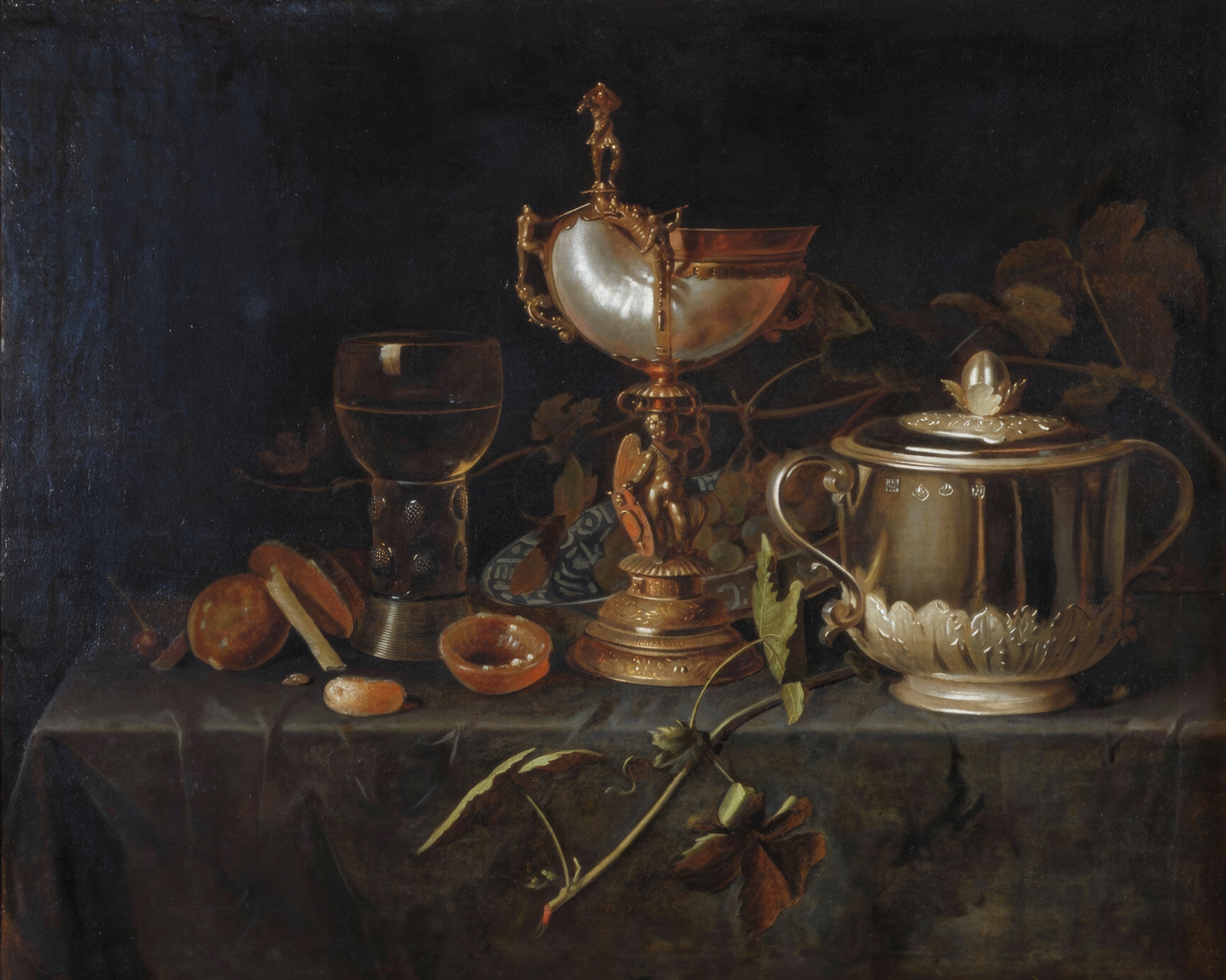A silver porringer and a gilt mounted nautilus shell cup gleam against a dark background.