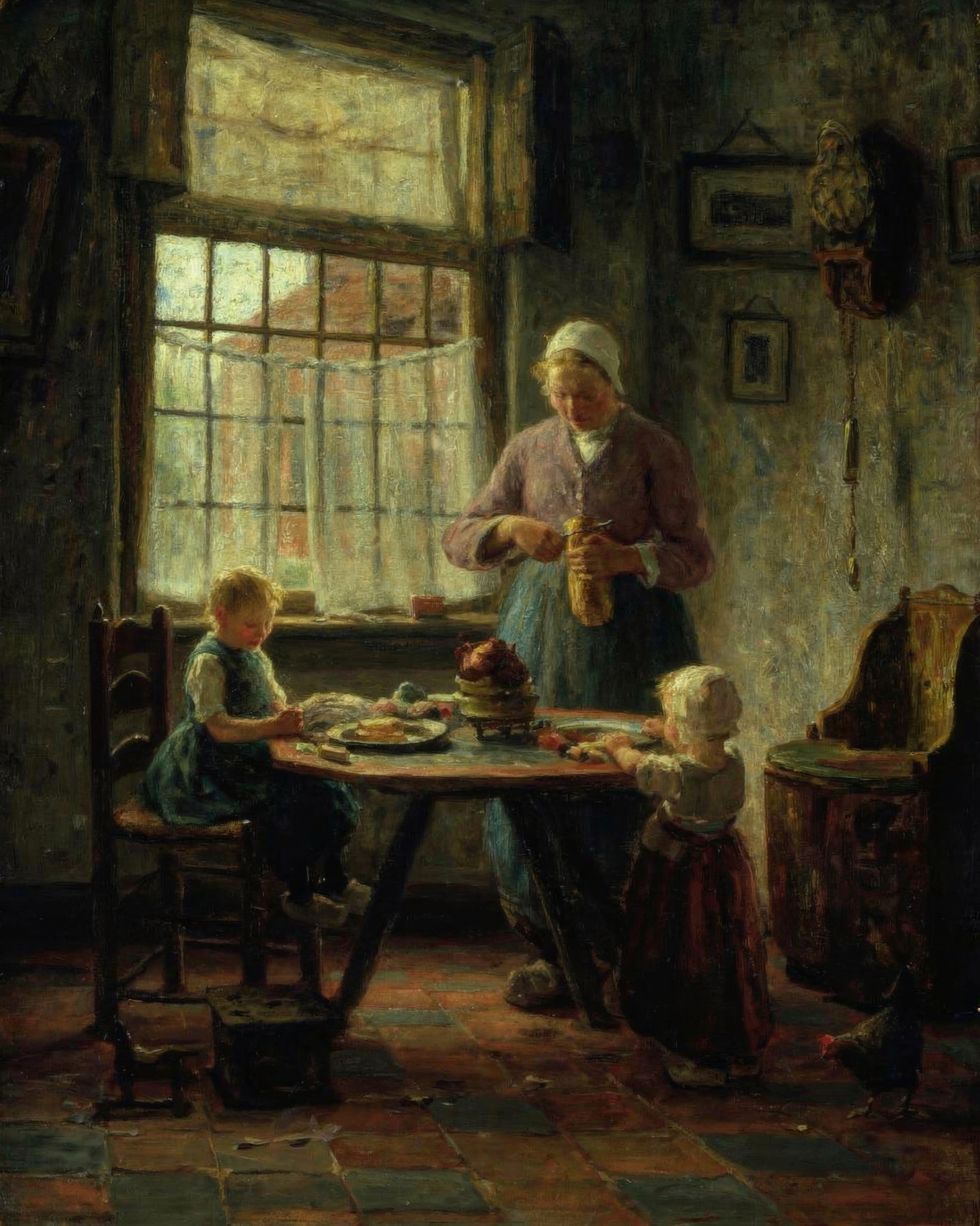 A mother spoons food to a child in a highchair while another child watches, in a softly lit room.