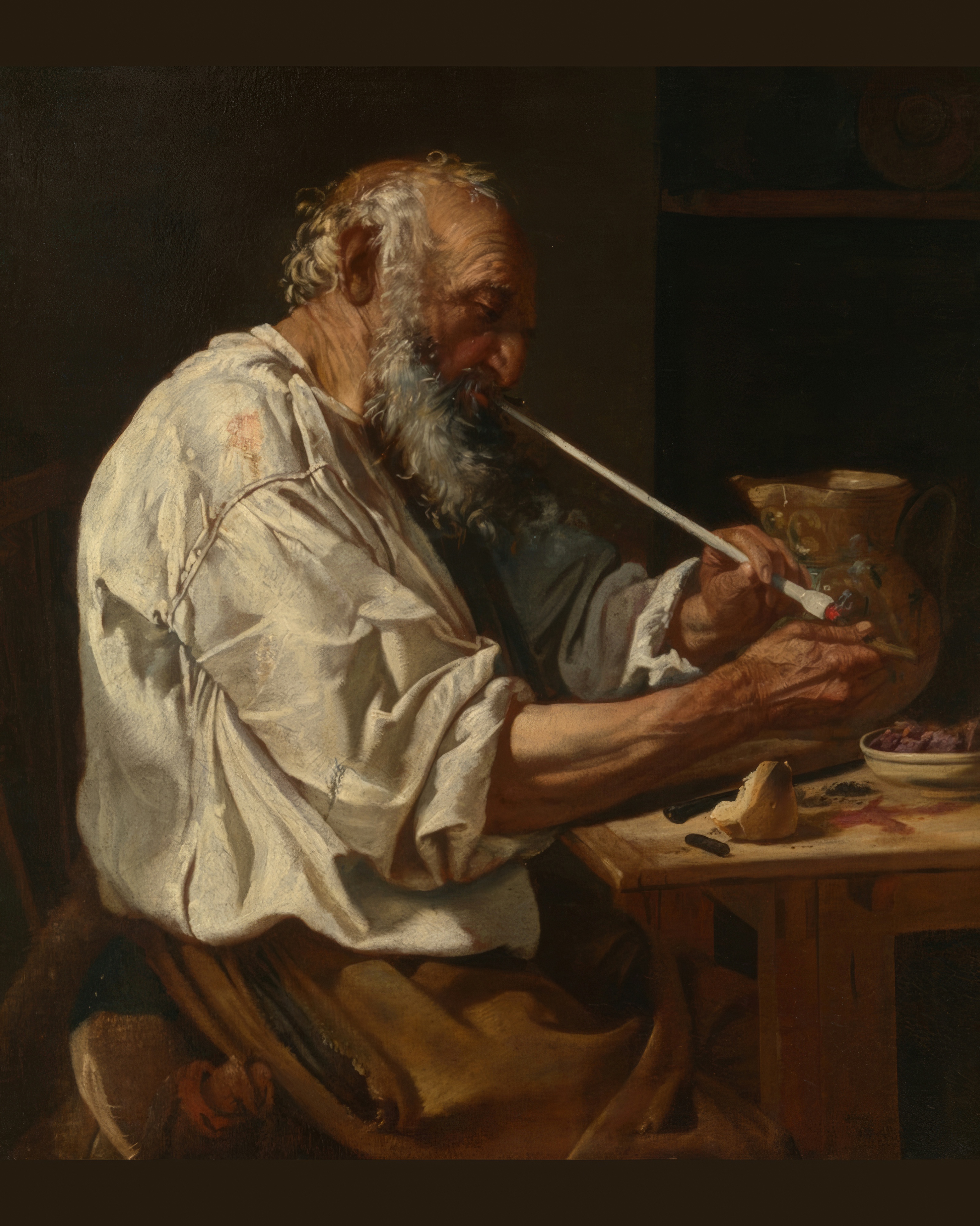 An old man with a lined face lights his pipe, lit by a single flame in the dark.