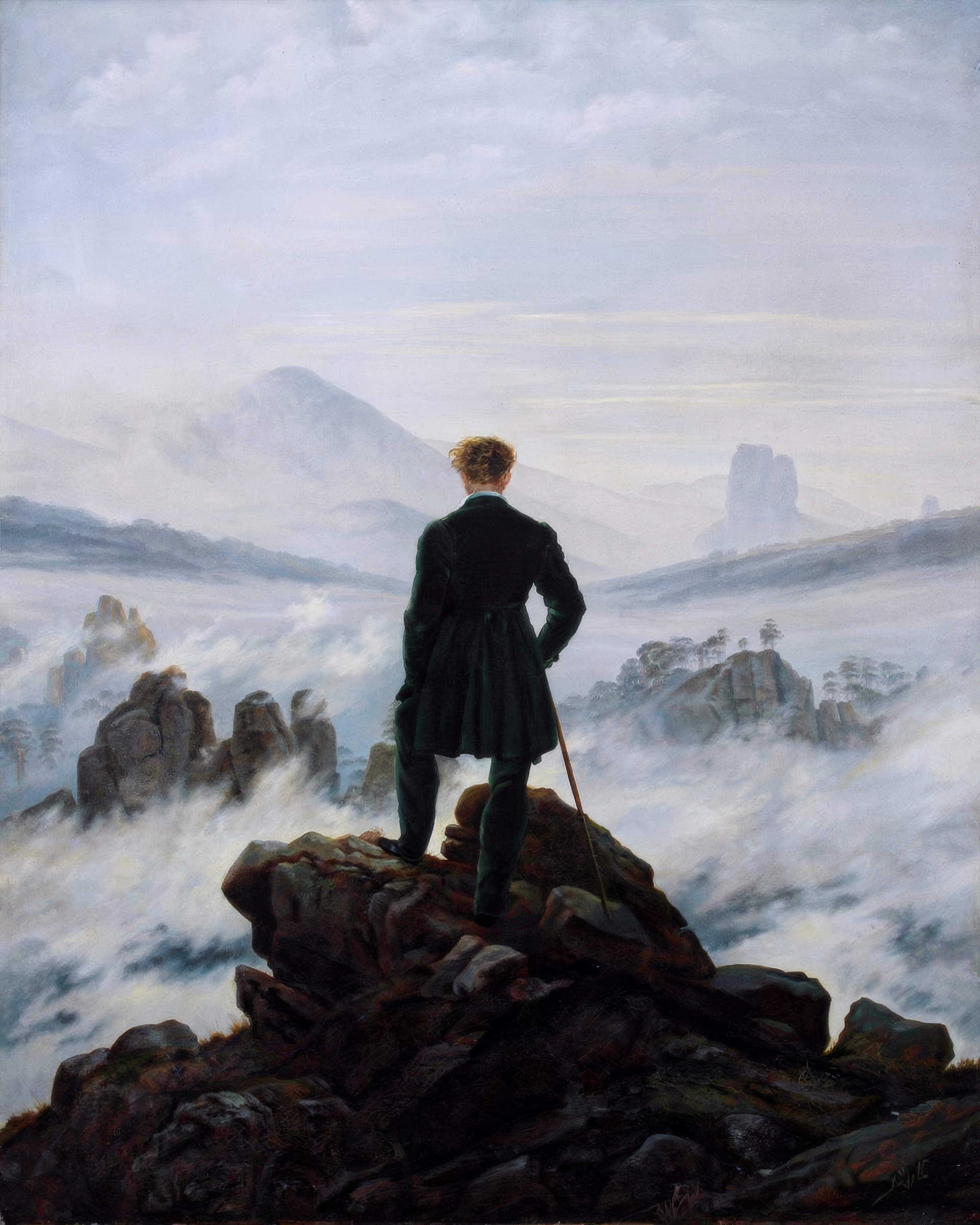 A man in a dark coat stands on a rocky peak with his back to us, looking over a sea of fog and mountains.