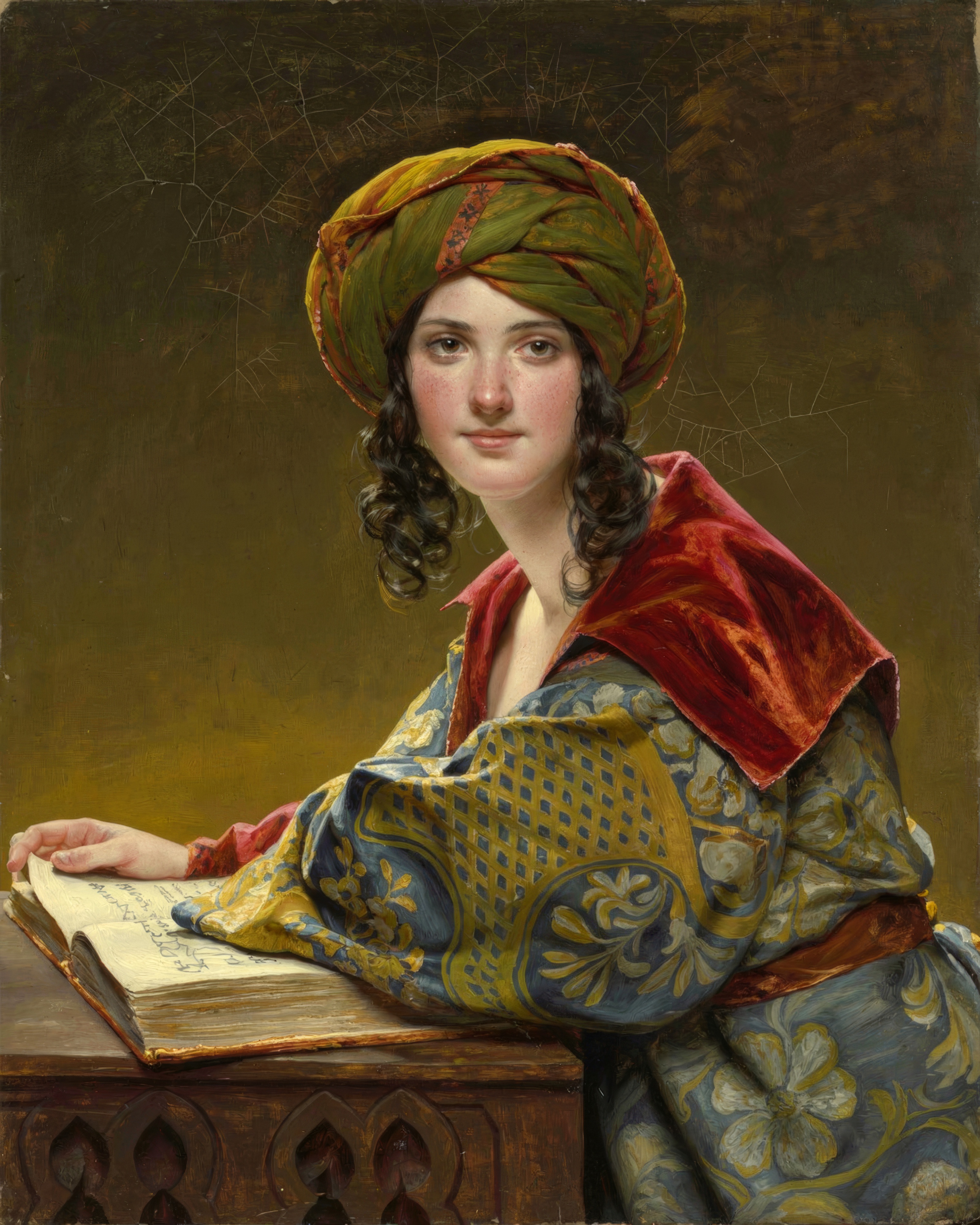 A young woman in an ornate headdress looks straight out at us.