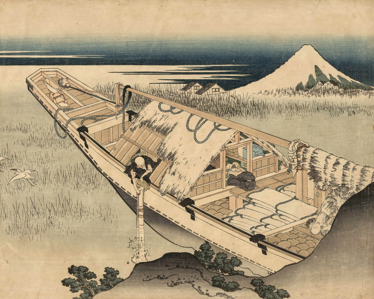 A boat rests on a still marsh with Mount Fuji rising in the distance through morning mist.
