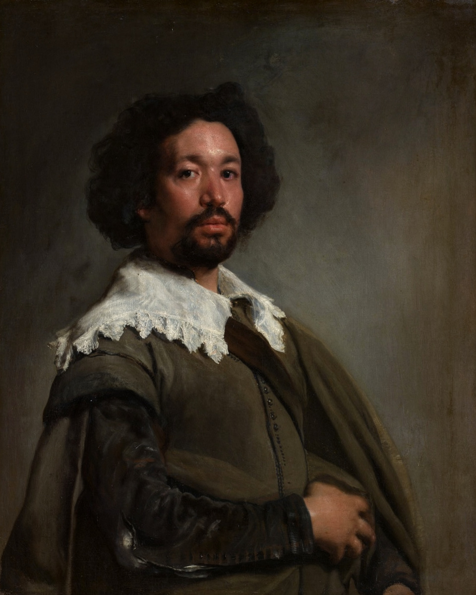Velázquez’s Juan de Pareja, a man with dark curly hair and a white lace collar looking directly towards the viewer, full artwork.