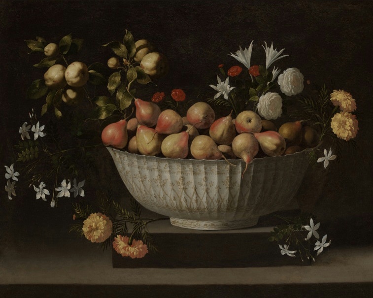 A white porcelain bowl filled with flowers and fruit on a ledge against a dark background.