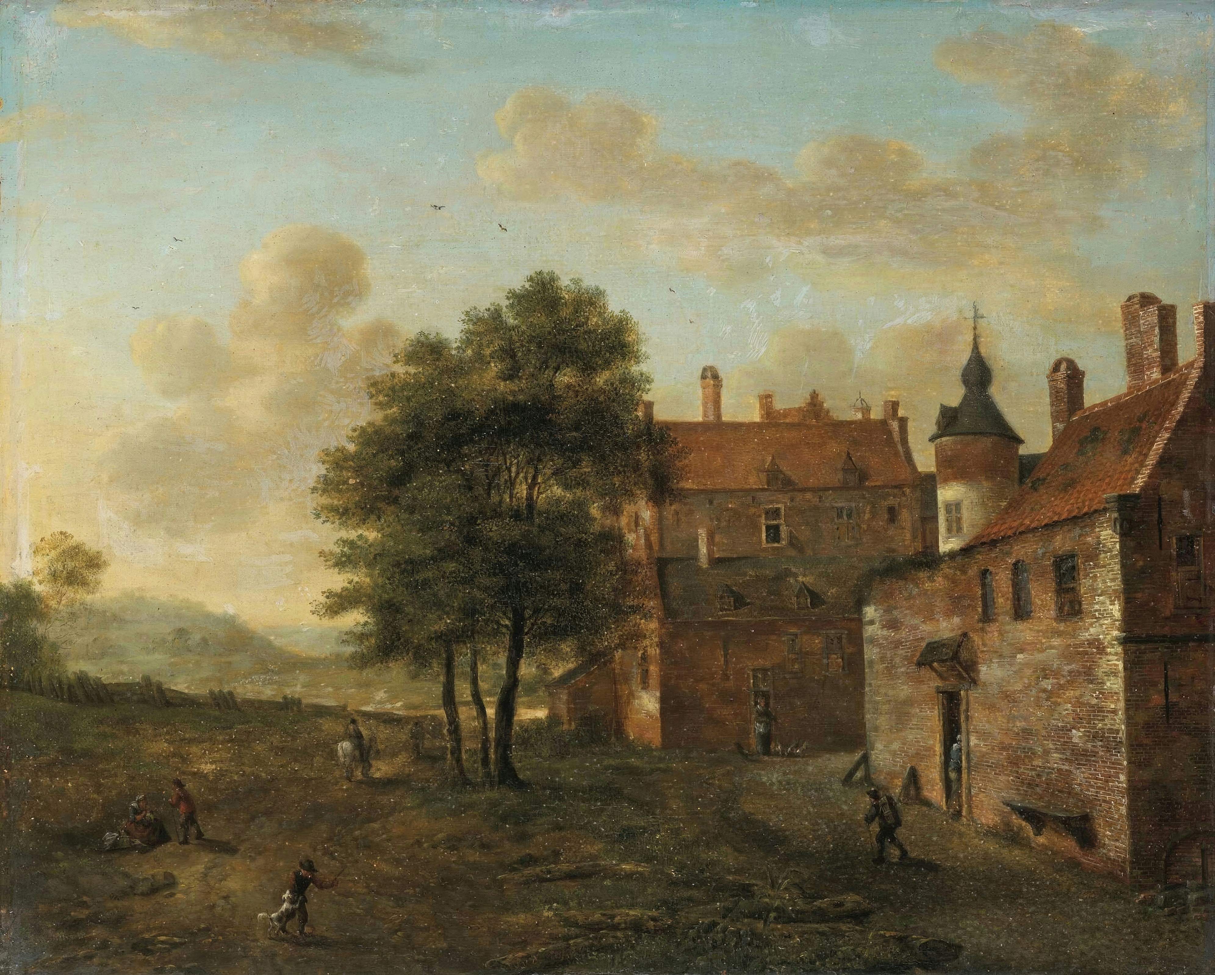 A brick manor complex with a turret under a cloudy sky, lit by golden evening light.
