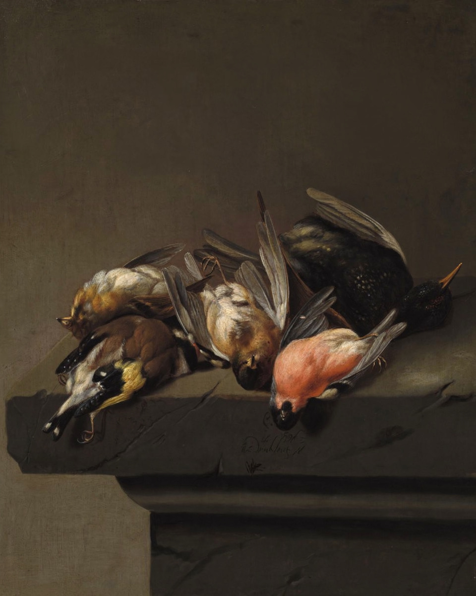 Game birds laid on a stone ledge against a dark background.