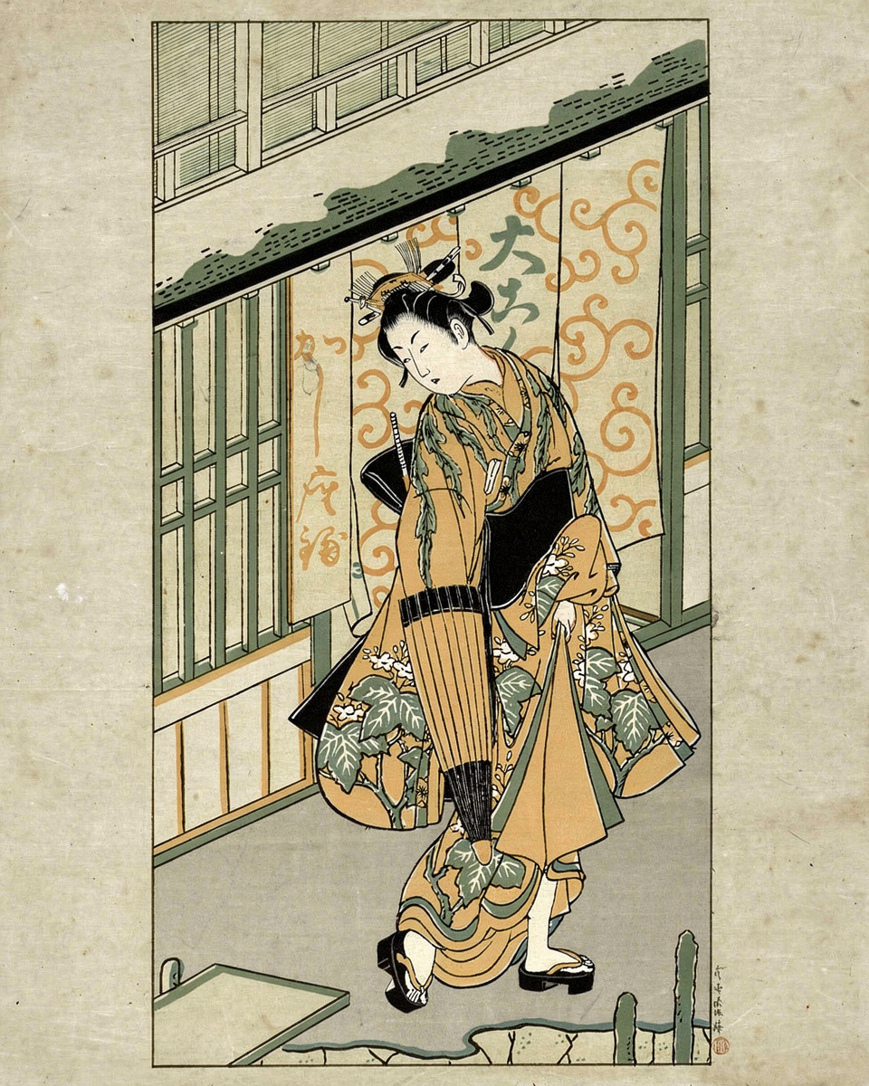 A young woman in a flowing kimono holds an open umbrella against a plain background.
